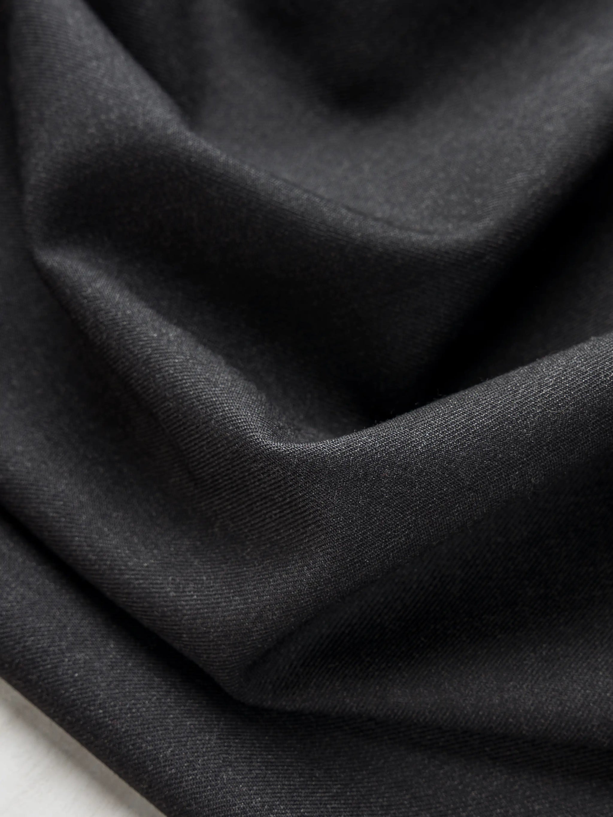 F-WOL120-Italian-Wool-Twill-Suiting-Deadstock-Charcoal-Core-Fabrics-scrunched.webp