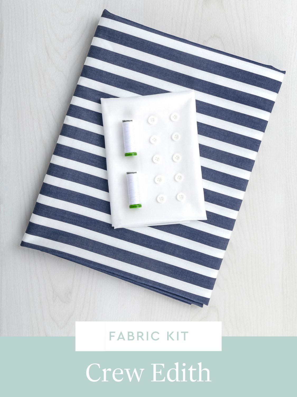 Fabric kit with blue and white striped fabric and sewing supplies for Edith Dress Pattern