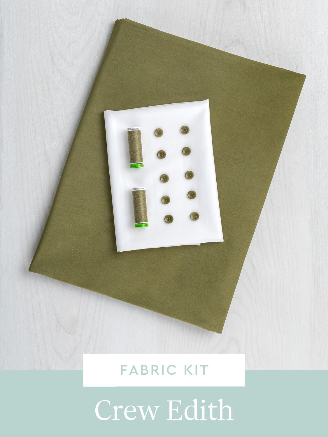 Fabric kit with spools of thread and buttons on a green fabric cover, branded 'Crew Edith'.