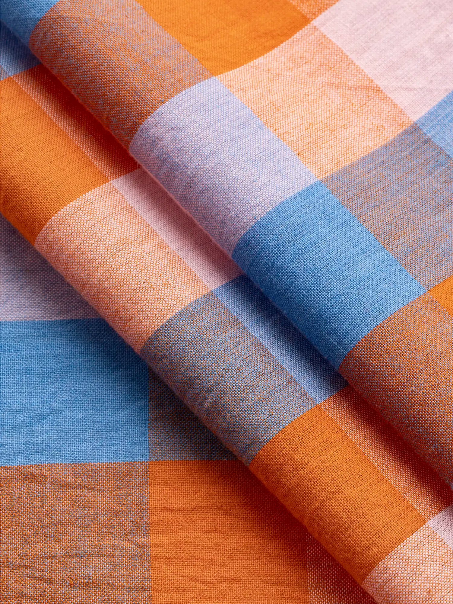 F-COT374-002-Kite-Handwoven-Check-Cotton-Sky-Petal-and-Orange-Core-Fabrics-fold.webp