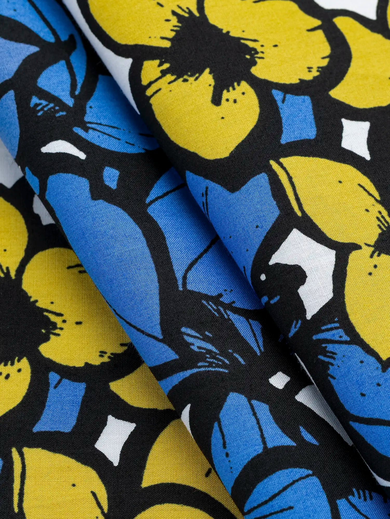 F-COT401-Large-Floral-Print-Japanese-Cotton-Lawn-White-Periwinkle-Black-and-Yellow-Core-Fabrics-fold.webp