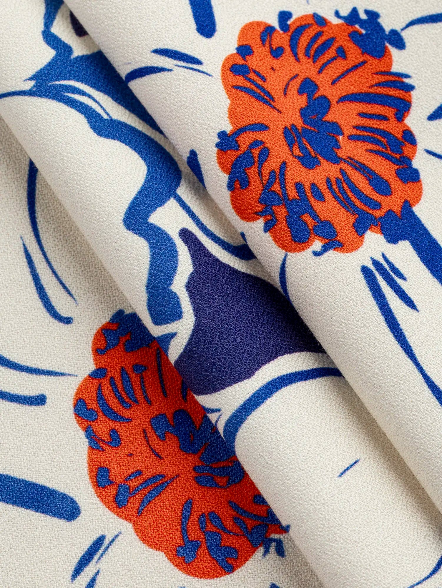 F-VIS305-Large-Flower-Print-FSC-Viscose-Crepe-Indigo-Ivory-and-Poppy-Core-Fabrics-fold.webp