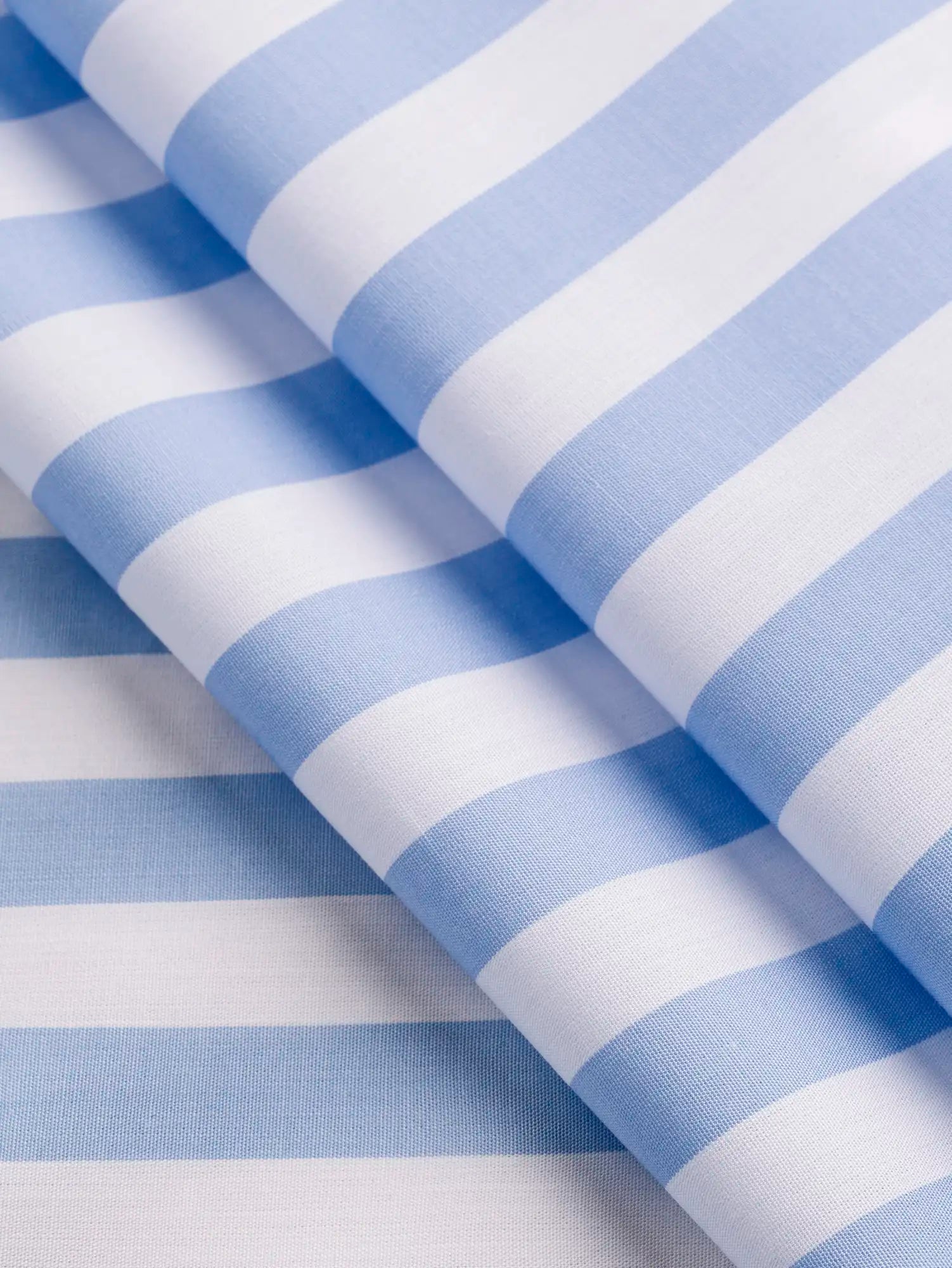 F-COT458-Large-Stripe-Cotton-Shirting-Sky-and-White-Core-Fabrics-fold.webp