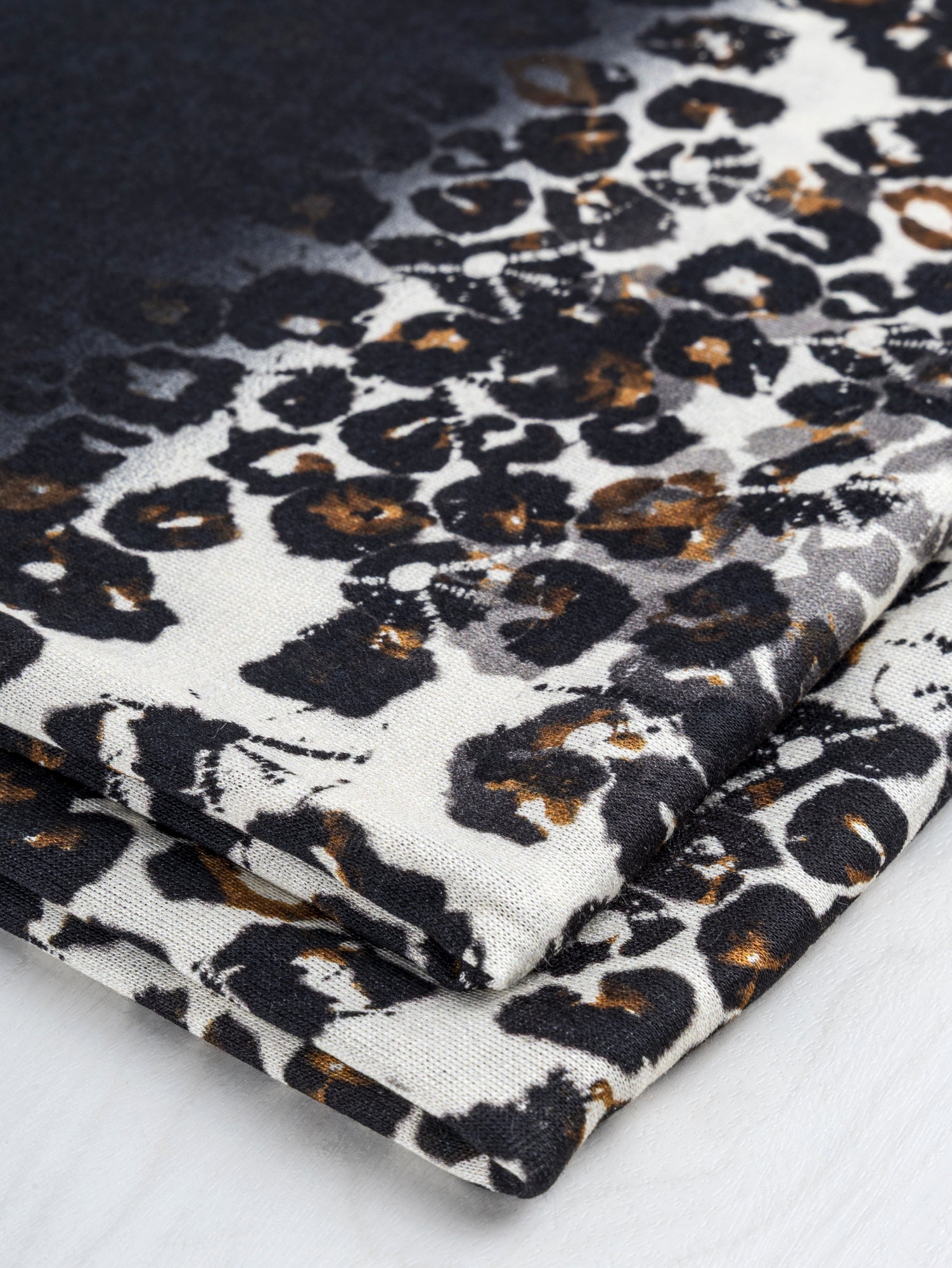 F-DEA074-Leopard-Panel-Print-Stretch-Cotton-Knit-Deadstock-Black+Ochre+Cream-Core-Fabrics-fold.JPG