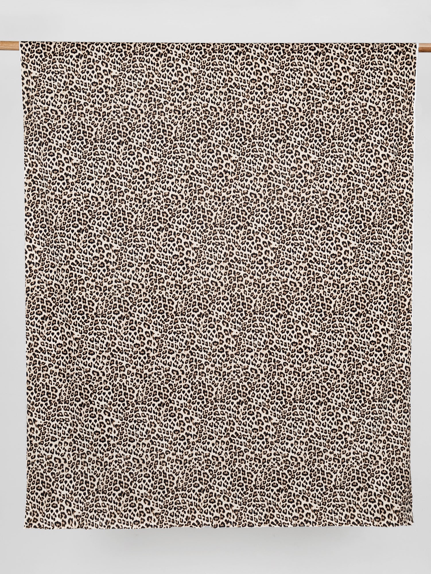 F-COT326-Leopard-Print-Stretch-Cotton-Bottomweight-Beige-Black-Core-Fabrics-draped