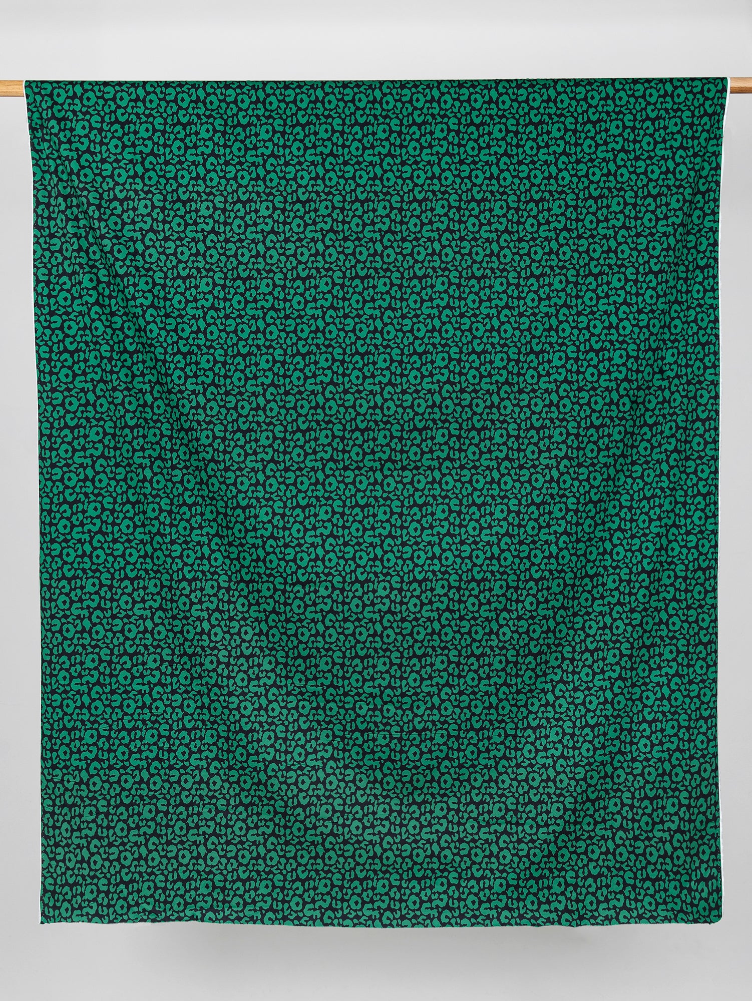 F-COT327-Leopard-Print-Stretch-Cotton-Bottomweight-Black-Green-Core-Fabrics-draped