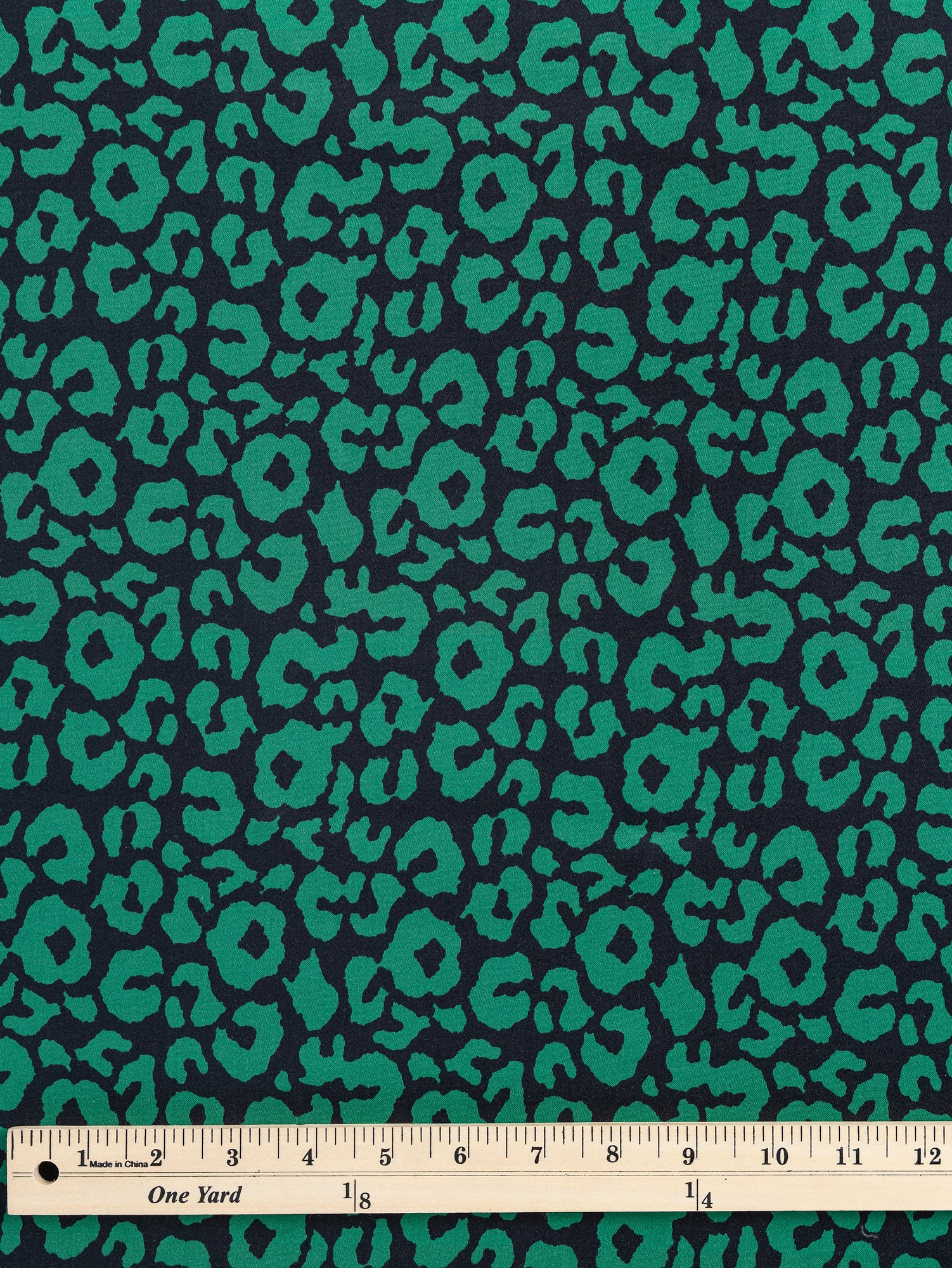 F-COT327-Leopard-Print-Stretch-Cotton-Bottomweight-Black-Green-Core-Fabrics-ruler