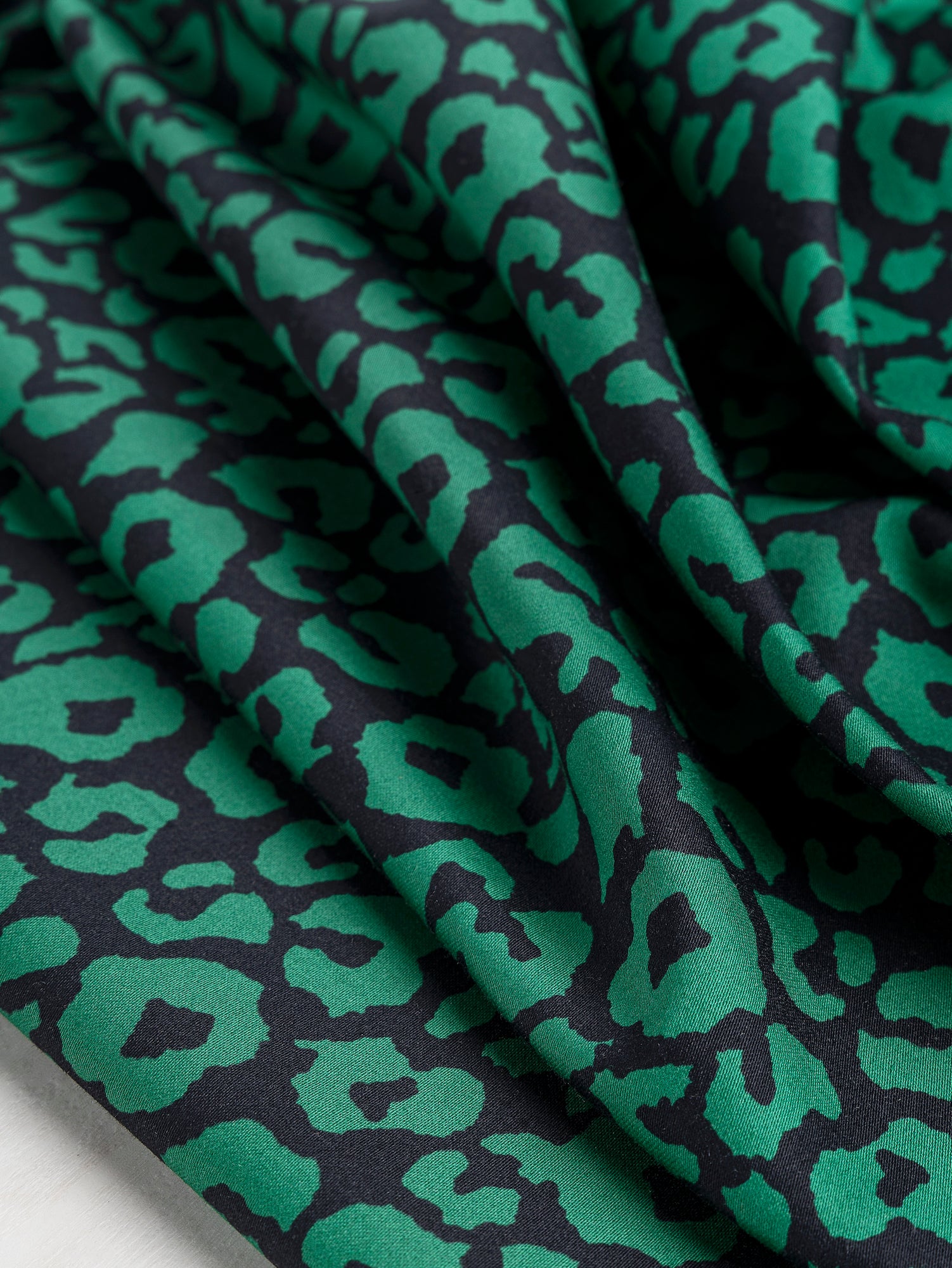 F-COT327-Leopard-Print-Stretch-Cotton-Bottomweight-Black-Green-Core-Fabrics-scrunched