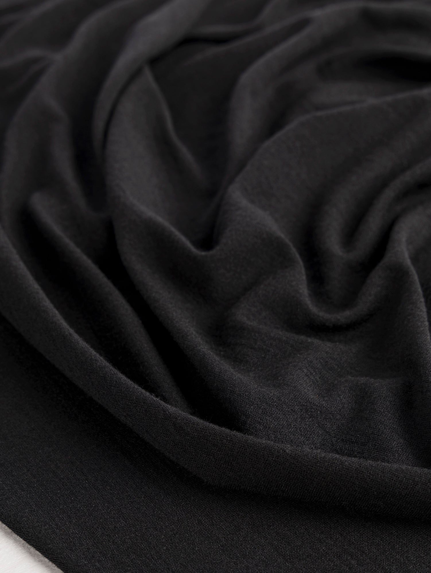 F-WOL128-001-Merino-Wool-Silk-Jersey-Knit-Deadstock-Black-Core-Fabrics-scrunched.JPG