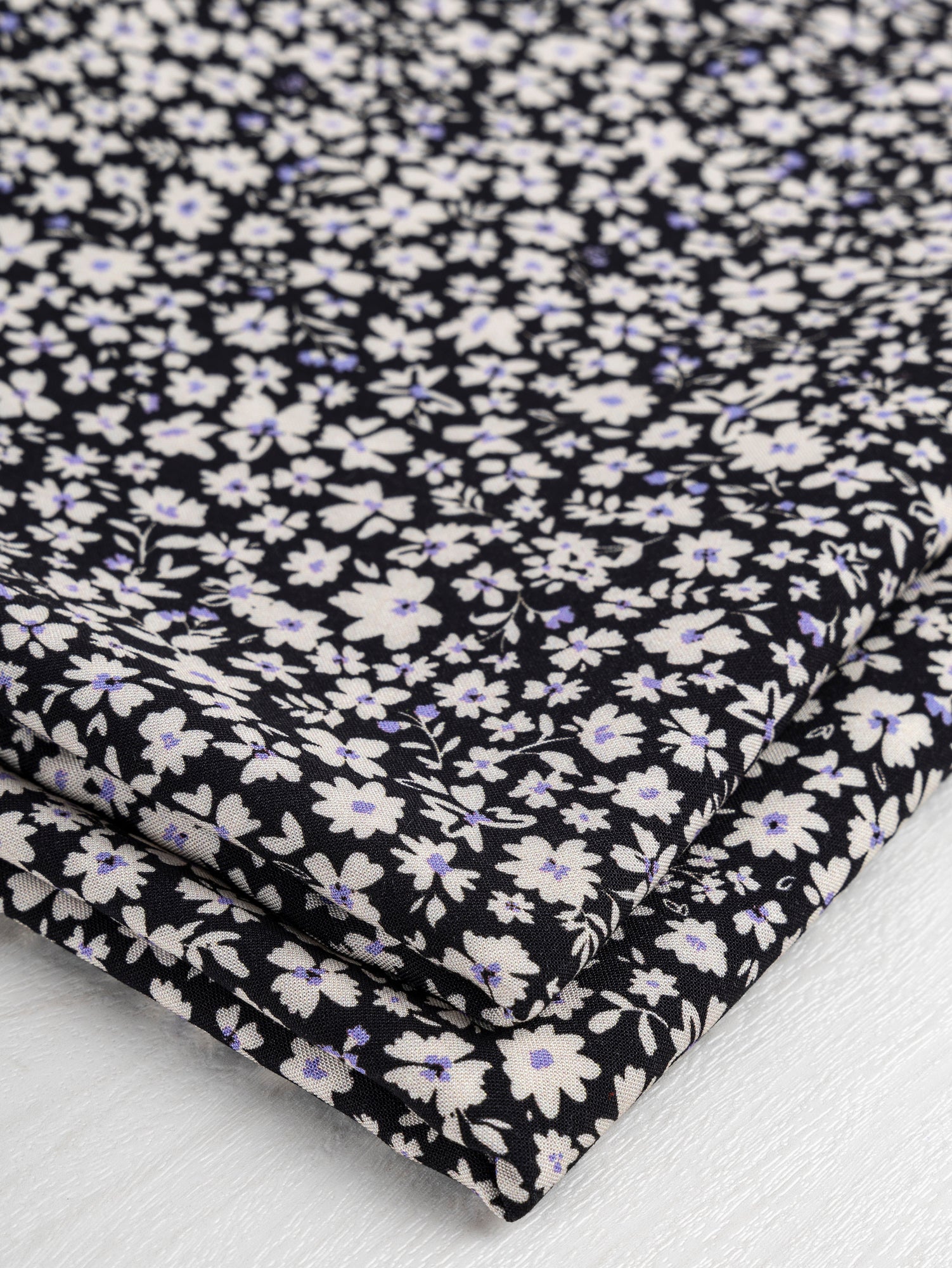 F-VIS242-Midnight-Ditzy-Floral-Print-Ecovero-Viscose-Black-Cream-Periwinkle-Core-Fabrics-fold.JPG