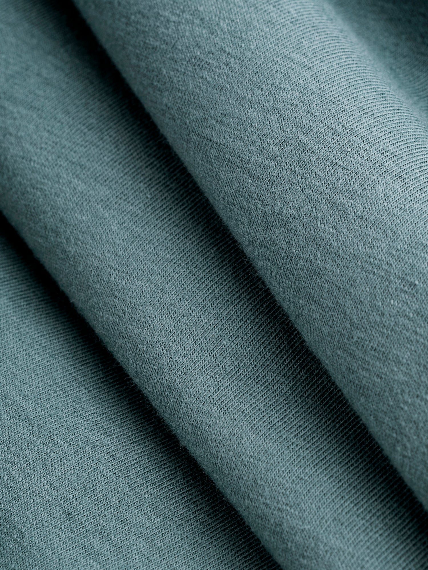 F-DEA085-003-Midweight-Organic-Cotton-Spandex-Jersey-Knit-Deadstock-Teal-Core-Fabrics-fold.JPG