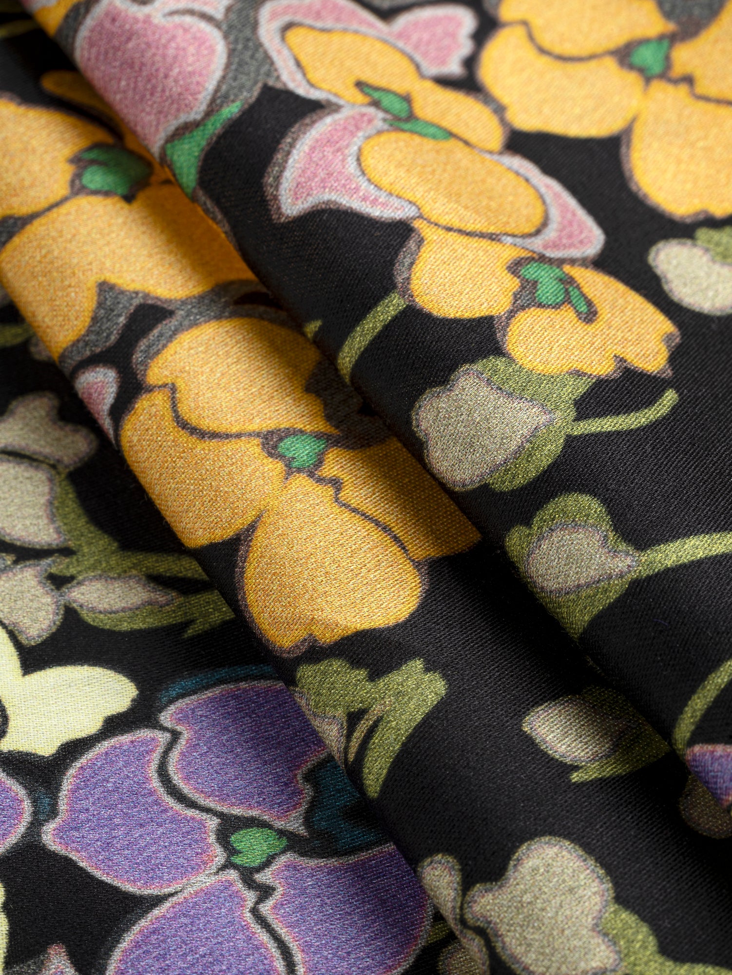 F-COT393-Orchids-Lilies-Of-The-Valley-Print-Cotton-Sateen-Black-Purple-Green-and-Orange-Core-Fabrics-fold.JPG