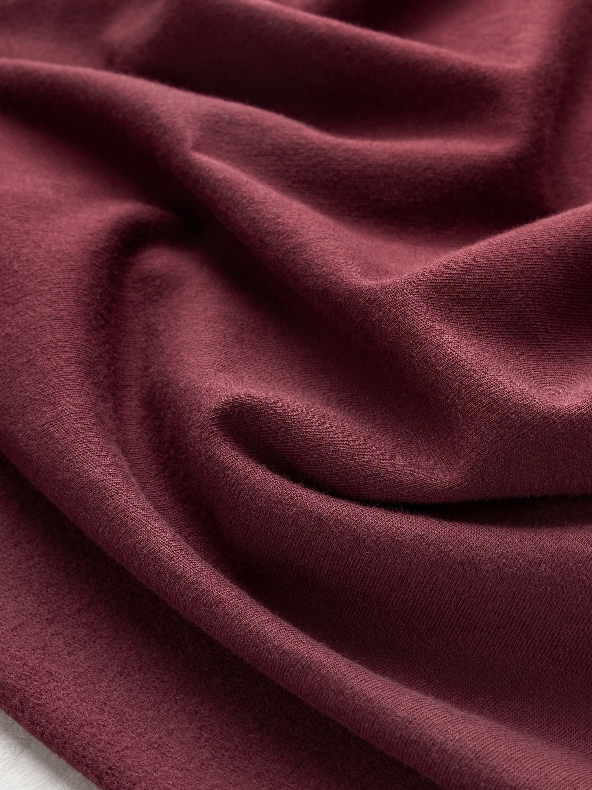 F-COT058-014-Organic-Cotton-Fleece-Bordeaux-Core-Fabrics-scrunched.webp