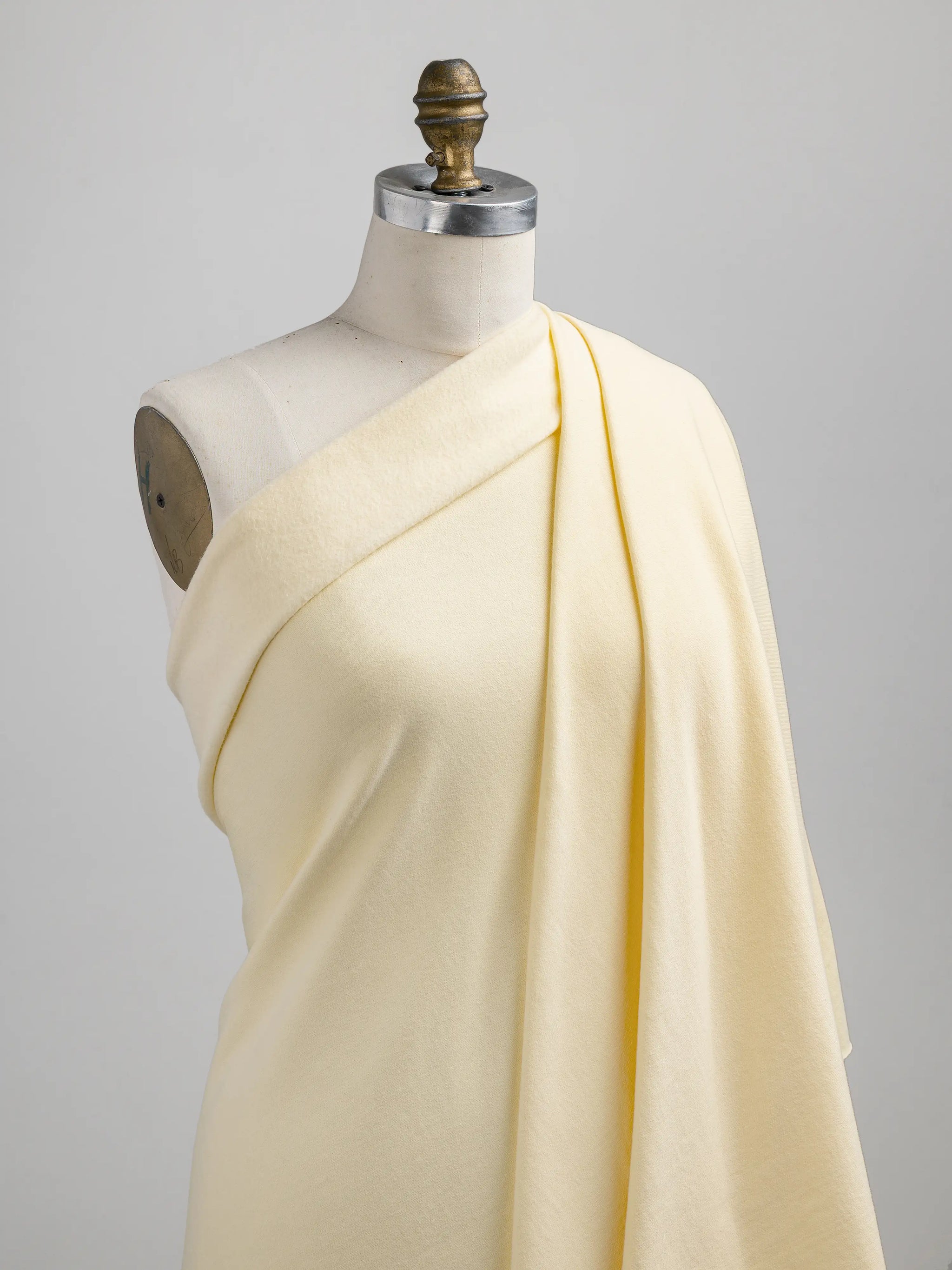 F-COT058-015-Organic-Cotton-Fleece-Butter-Yellow-Core-Fabrics-draped.webp
