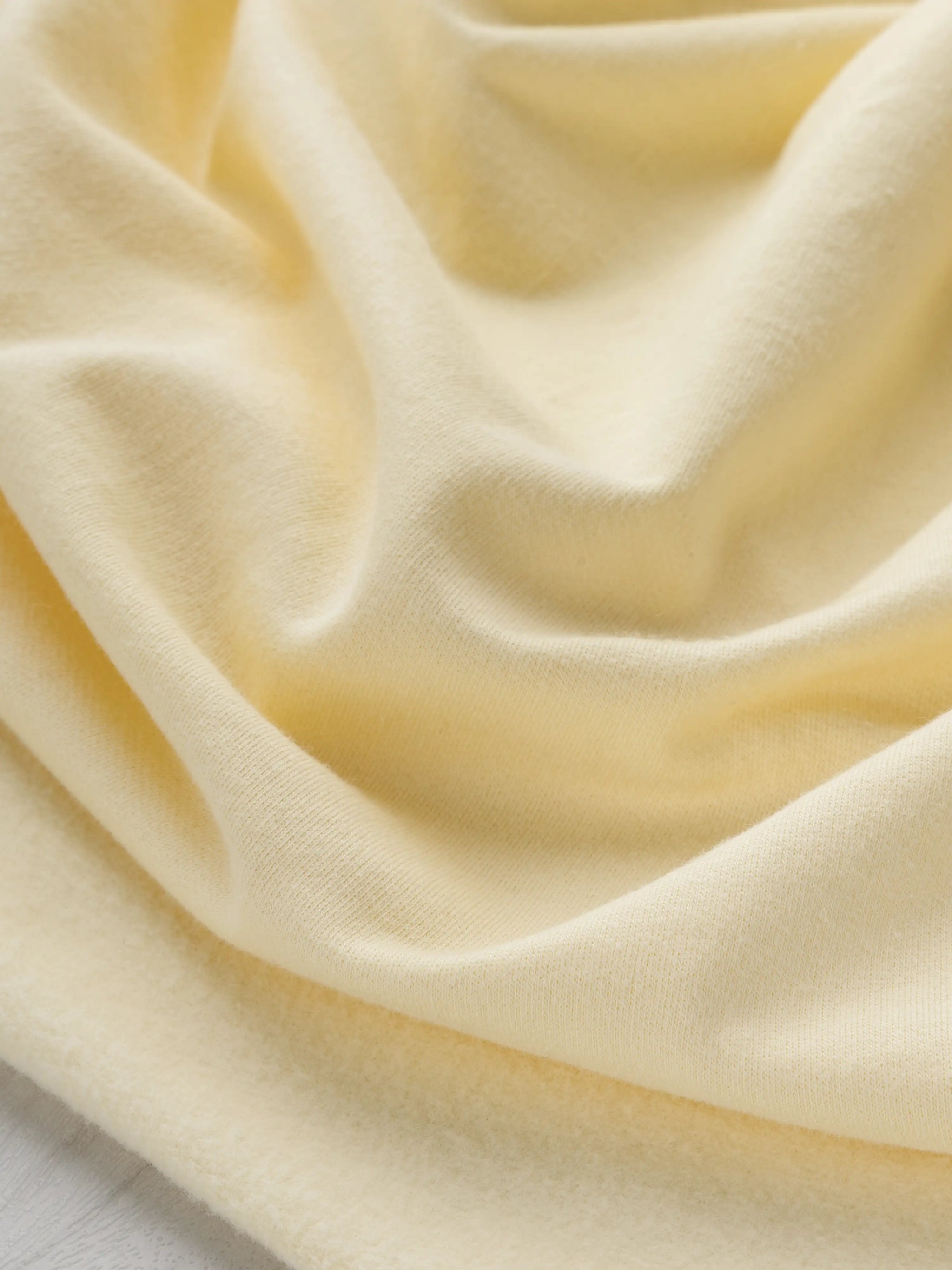 F-COT058-015-Organic-Cotton-Fleece-Butter-Yellow-Core-Fabrics-scrunched.webp