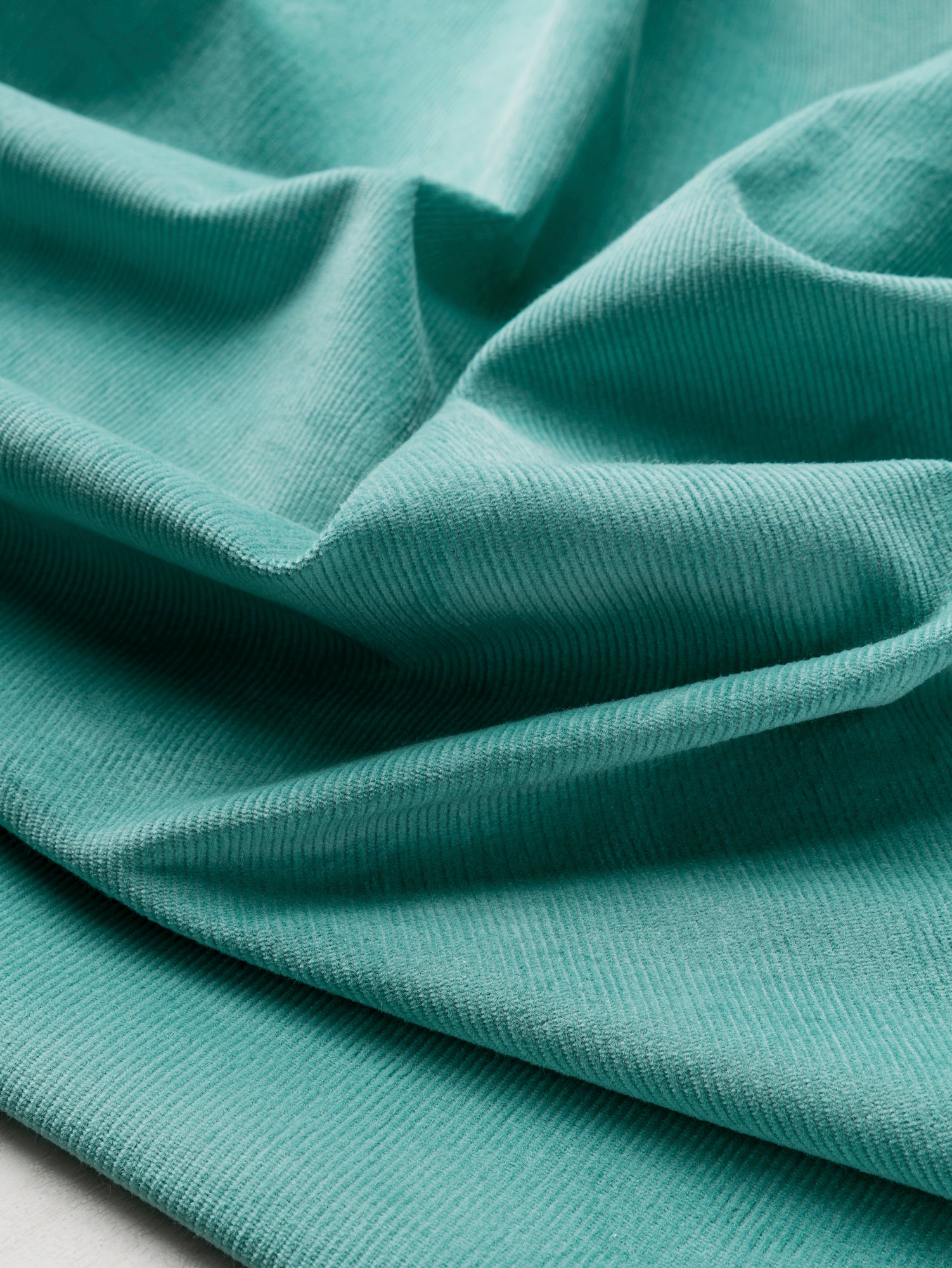 F-COT408-Organic-Cotton-Lycra-Slight-Stretch-14-Wale-Corduroy-Teal-Core-Fabrics-scrunched.JPG