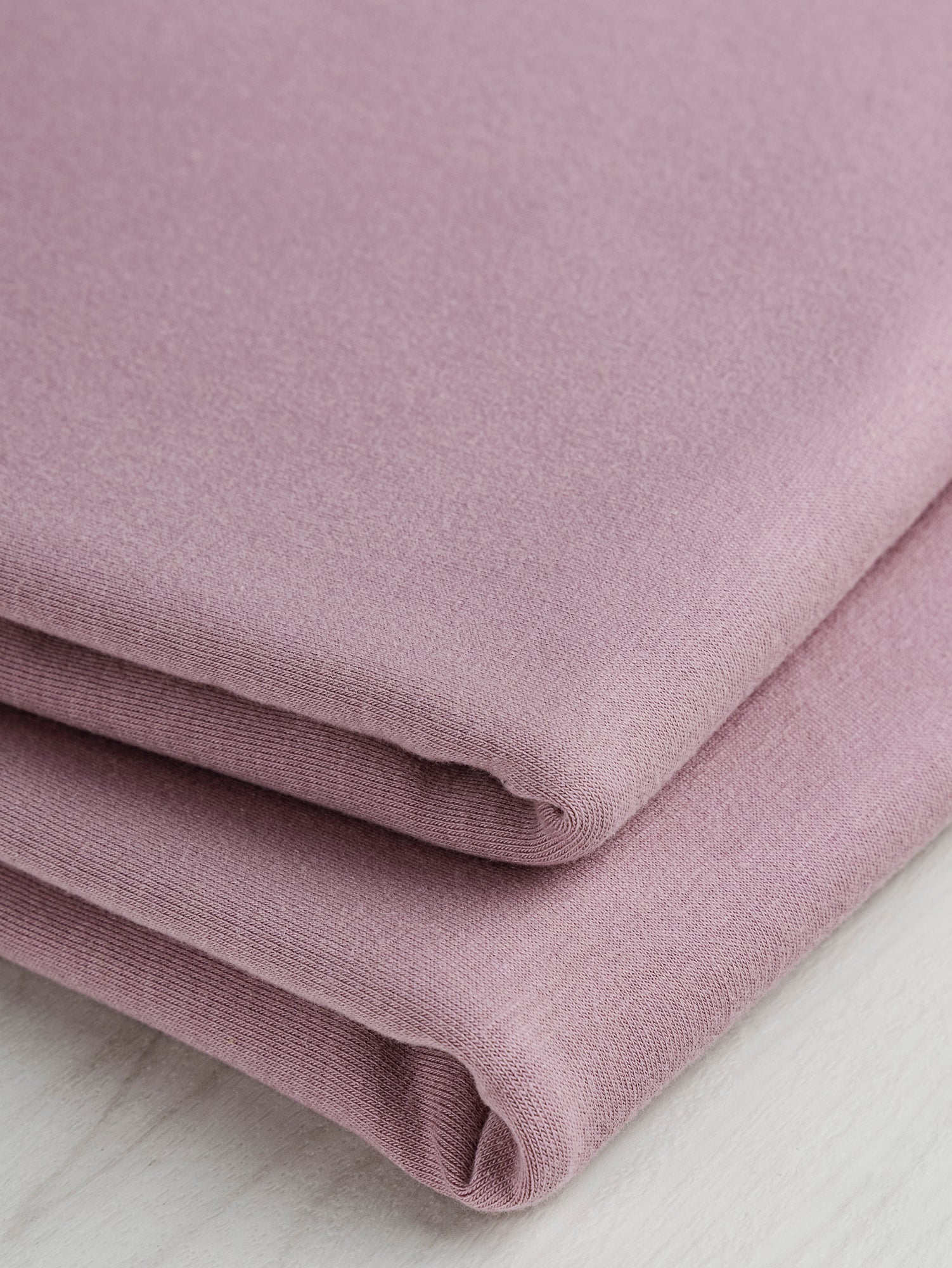 F-COT363-006-Organic-Cotton-Spandex-Jersey-Knit-Lilac-Core-Fabrics-fold.JPG