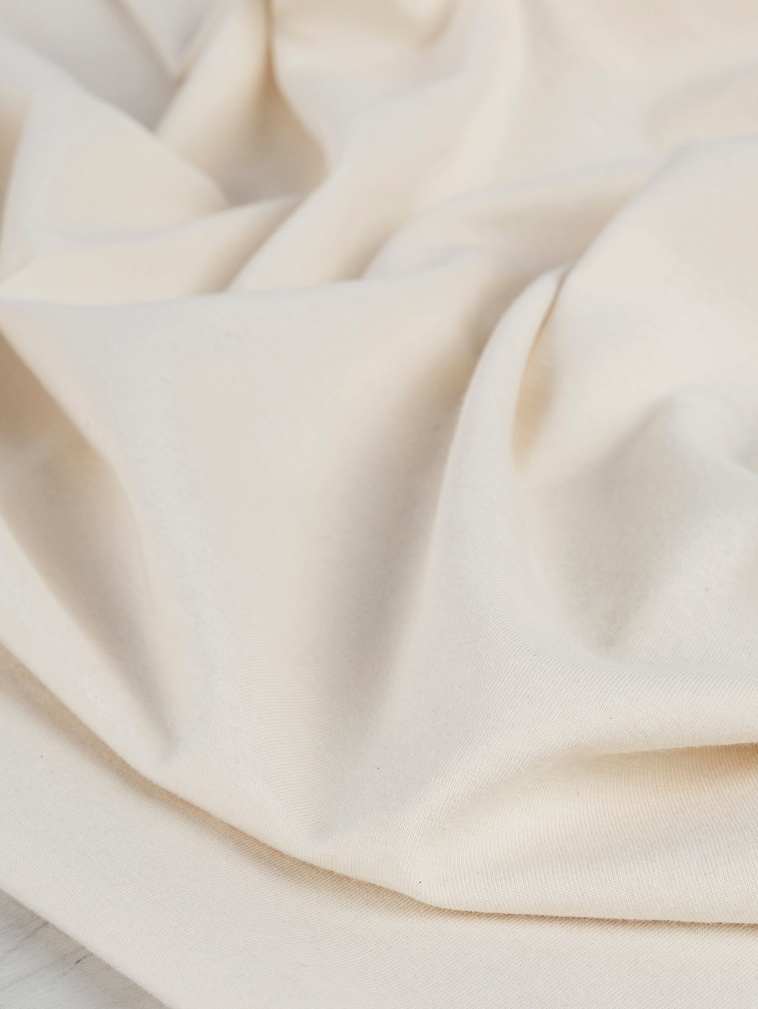 F-COT363-009-Organic-Cotton-Spandex-Jersey-Knit-Natural-Core-Fabrics-scrunched.JPG
