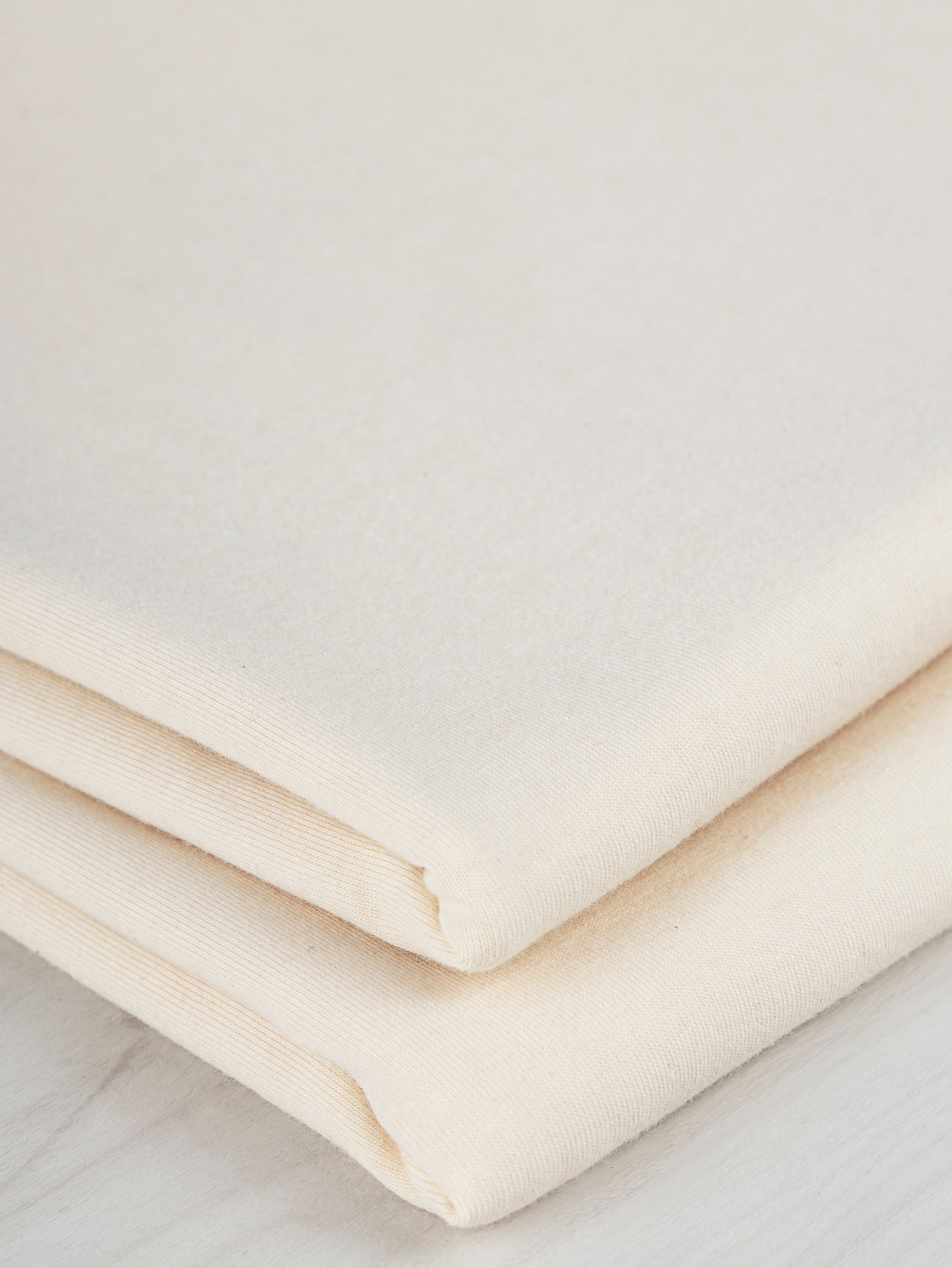 F-COT363-009-Organic-Cotton-Spandex-Jersey-Knit-Natural-Core-Fabrics-fold.JPG