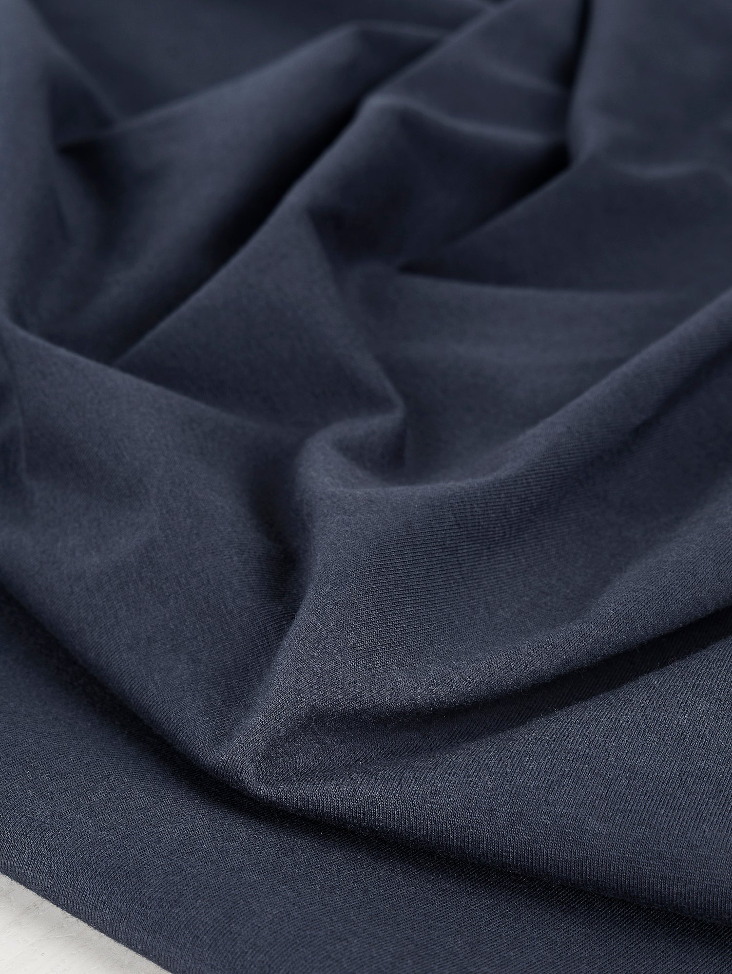 F-COT363-002-Organic-Cotton-Spandex-Jersey-Knit-Navy-Core-Fabrics-scrunched.JPG