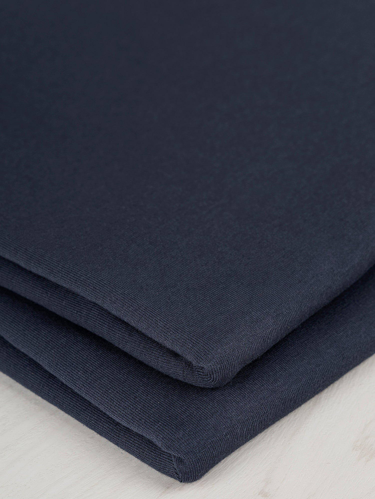 F-COT363-002-Organic-Cotton-Spandex-Jersey-Knit-Navy-Core-Fabrics-fold.JPG