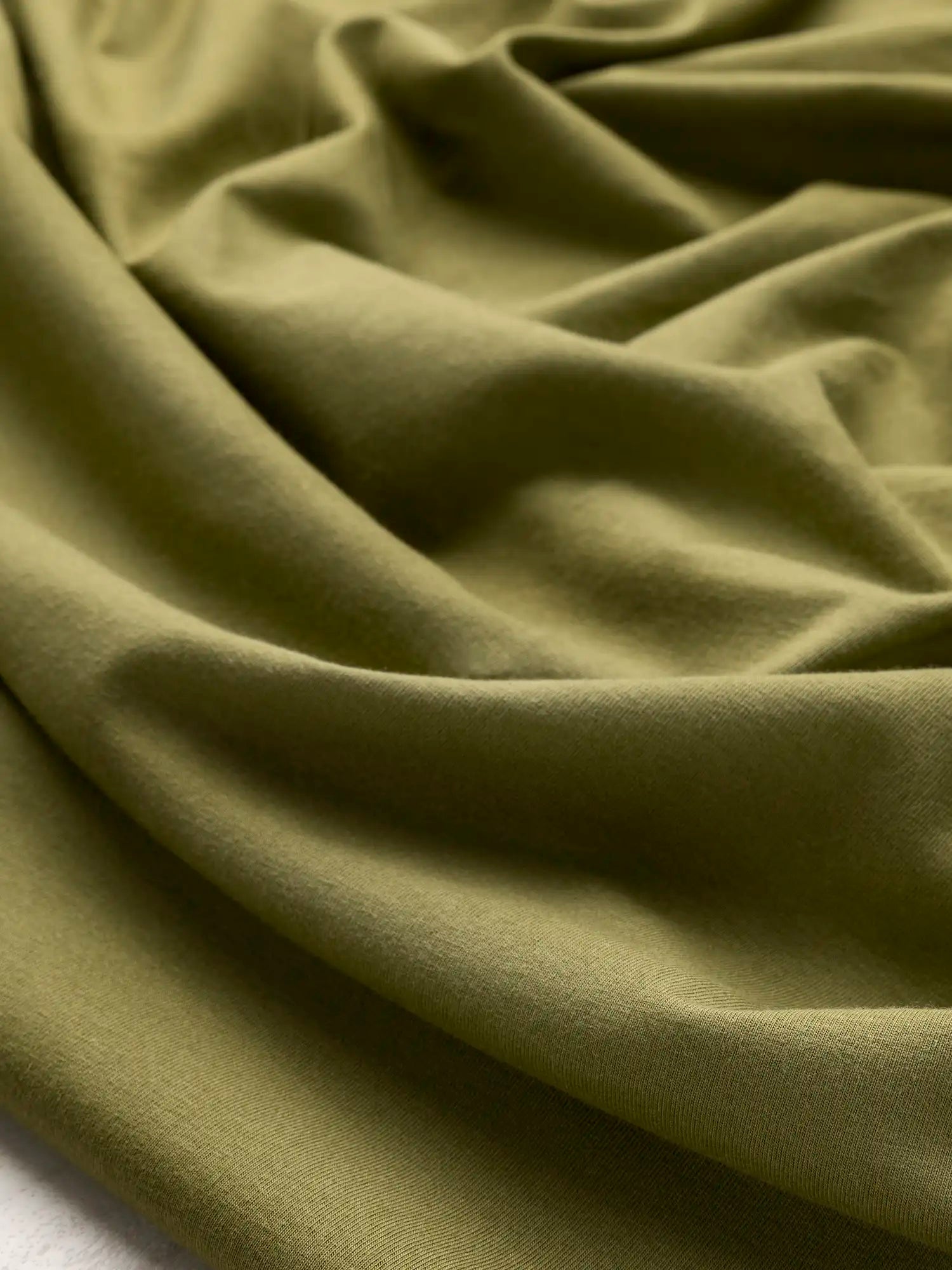 F-COT363-022-Organic-Cotton-Spandex-Jersey-Knit-Olive-Core-Fabrics-scrunched.webp