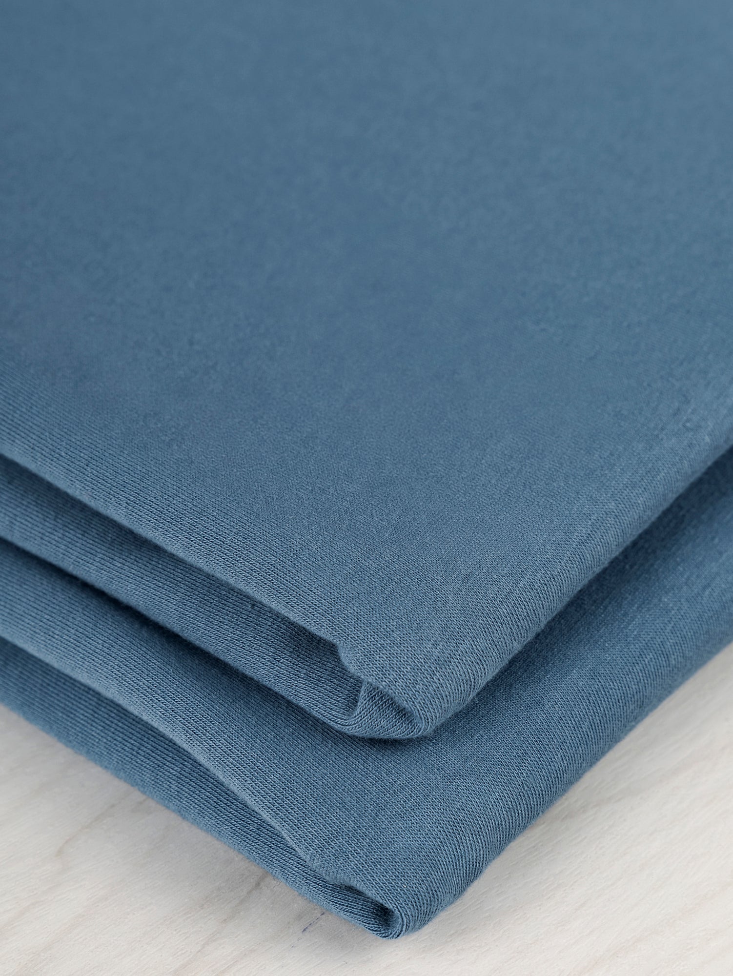 F-COT363-011-Organic-Cotton-Spandex-Jersey-Knit-Steel-Blue-Core-Fabrics-fold.JPG