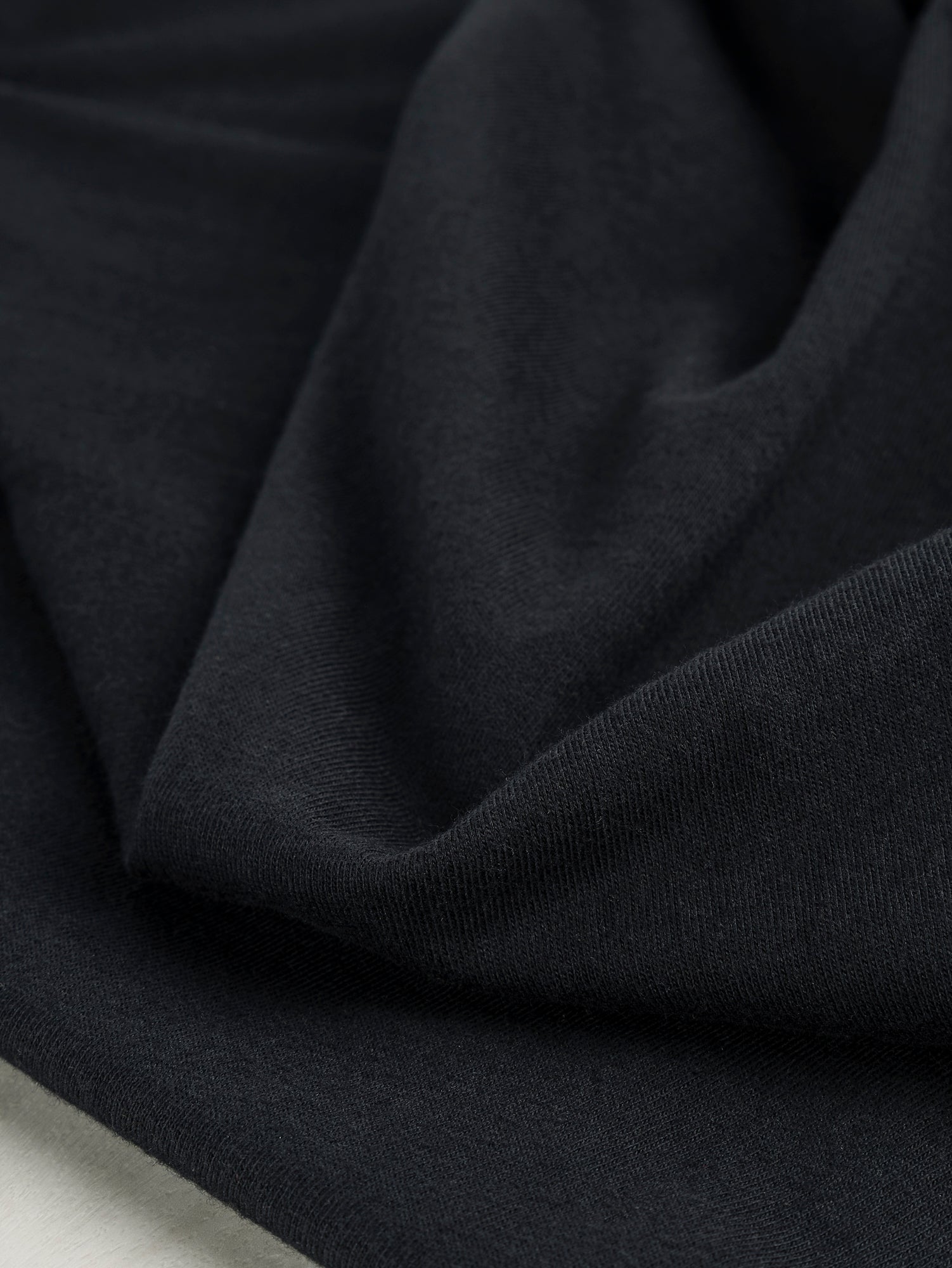 F-COT361-001-Organic-Cotton-Washed-Jersey-Knit-Black-Core-Fabrics-scrunched.JPG