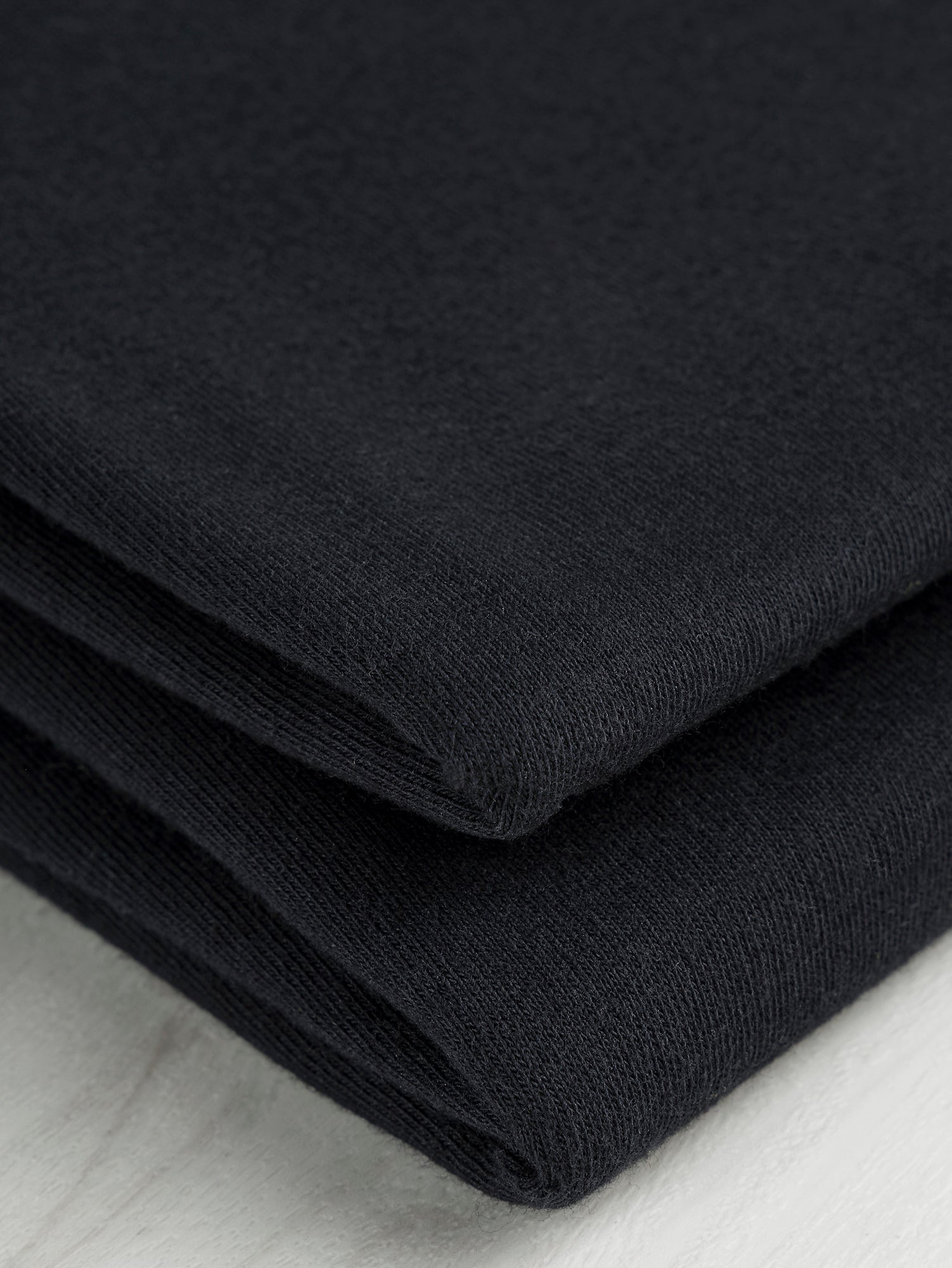 F-COT361-001-Organic-Cotton-Washed-Jersey-Knit-Black-Core-Fabrics-fold.JPG