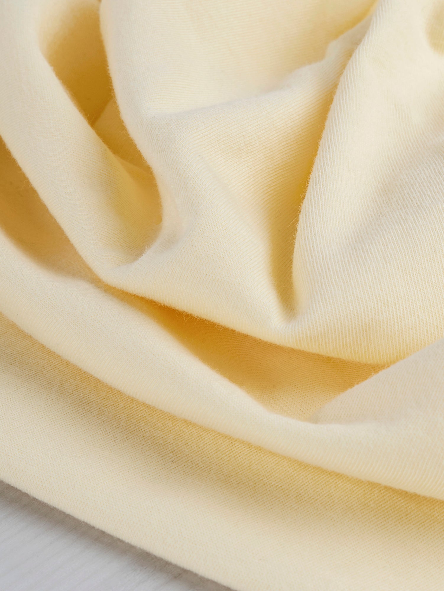 F-COT361-015-Organic-Cotton-Washed-Jersey-Knit-Butter-Yellow-Core-Fabrics-scrunched.JPG