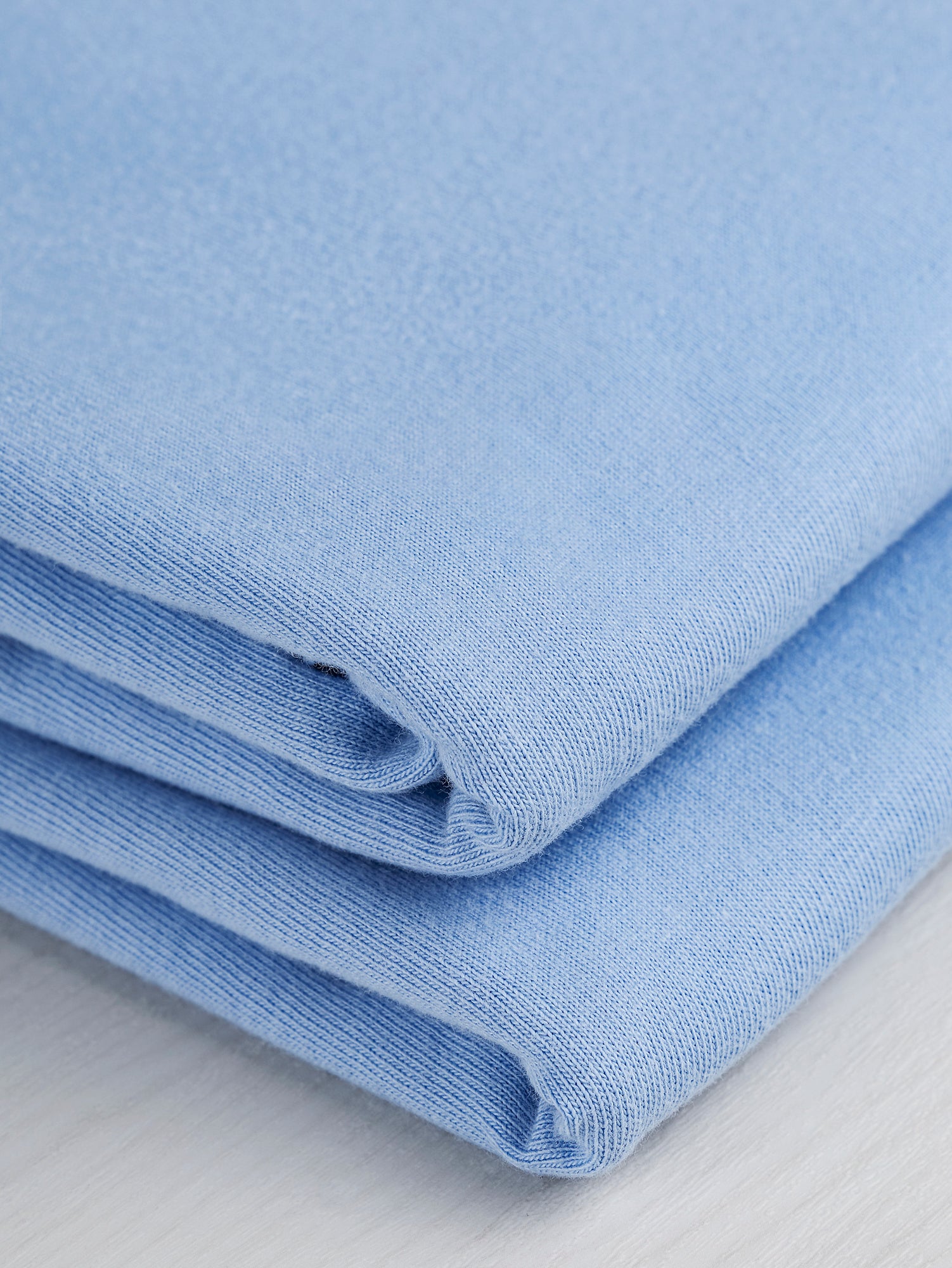 F-COT361-016-Organic-Cotton-Washed-Jersey-Knit-Powder-Blue-Core-Fabrics-fold.JPG