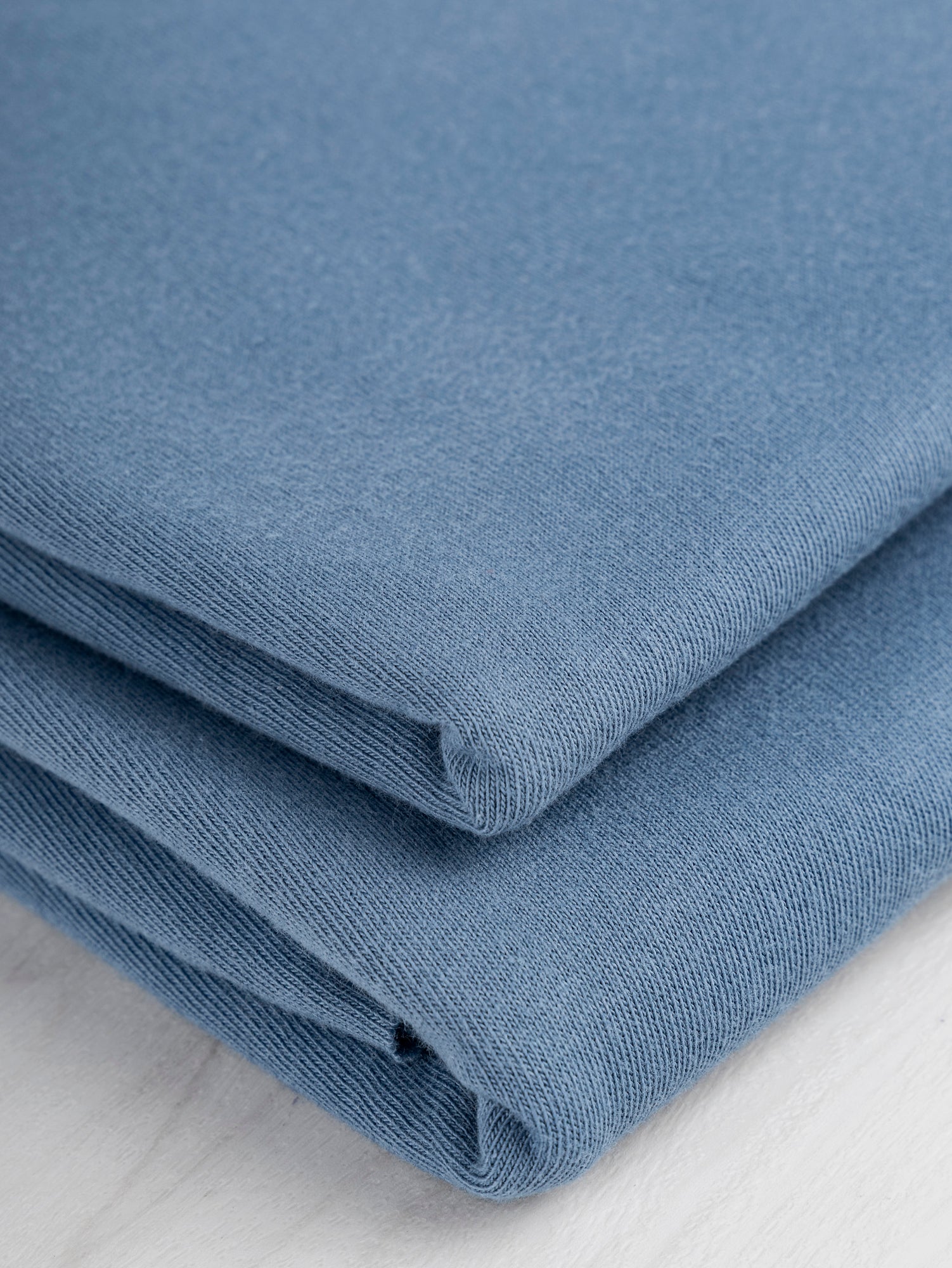 F-COT361-011-Organic-Cotton-Washed-Jersey-Knit-Steel-Blue-Core-Fabrics-fold.JPG