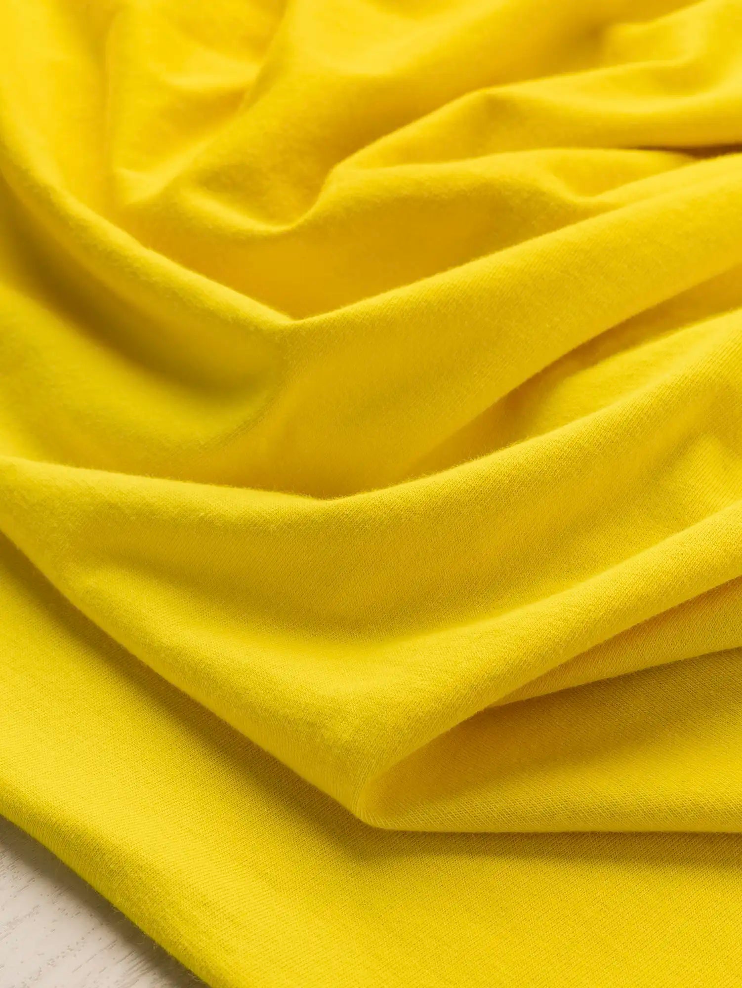 F-COT361-019-Organic-Cotton-Washed-Jersey Knit-Sunshine-Core-Fabrics-scrunched.webp