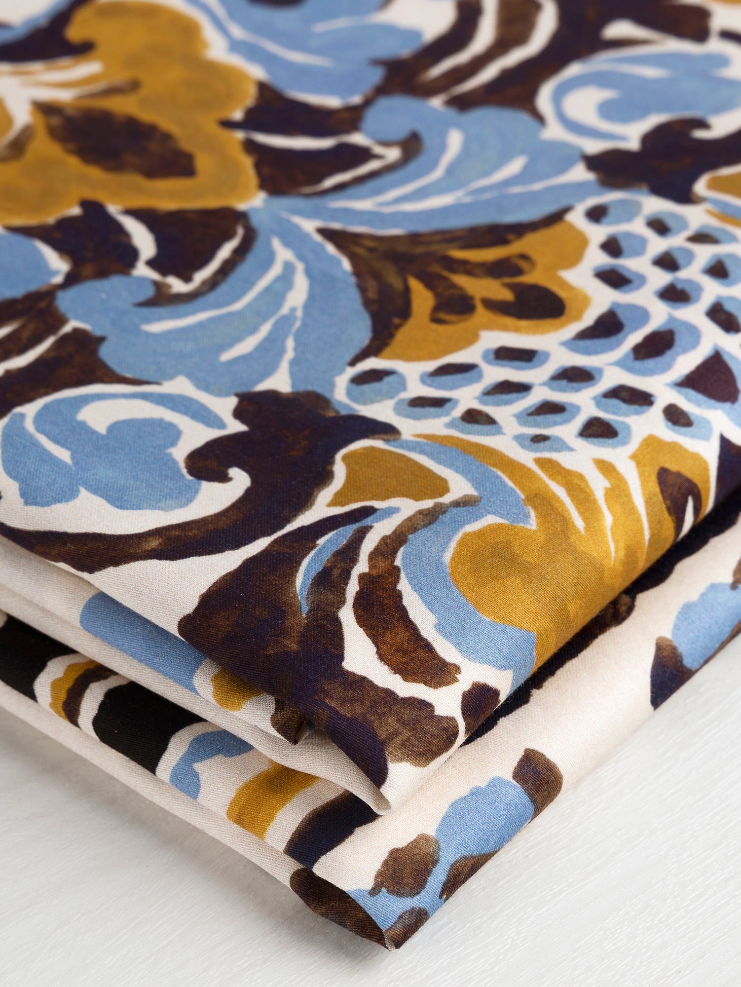 F-COT331-Ornamental-Panel-Print-Cotton-Lawn-Cream-Black-Ochre -and-Periwinkle-Core-Fabrics-fold.JPG