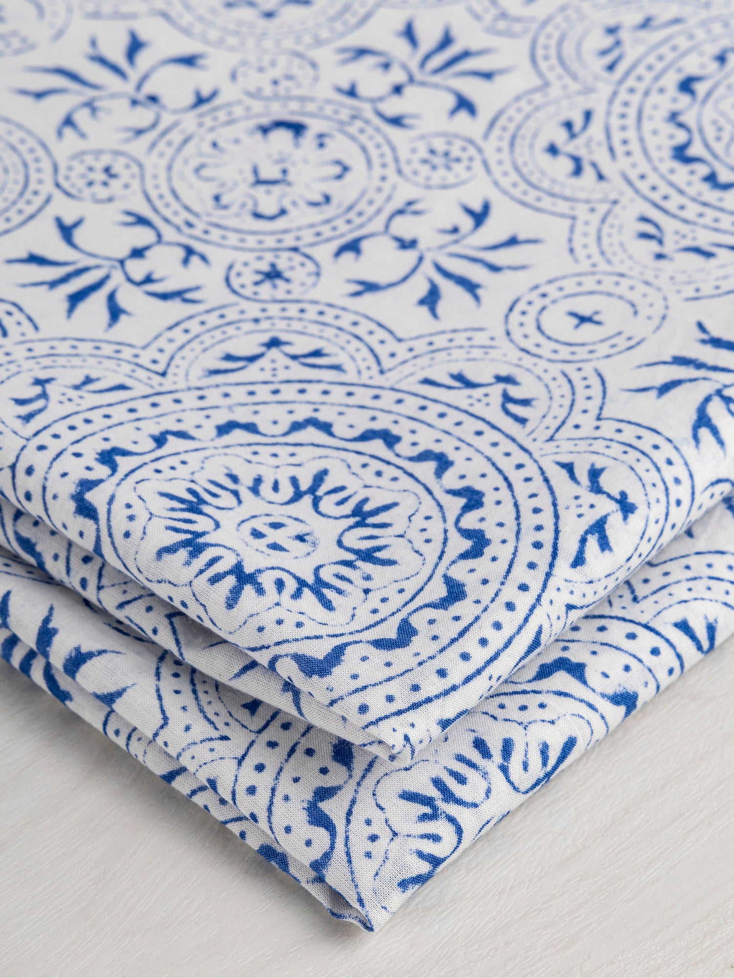 F-COT351-002-Ornement-Block-Print-Cotton-Voile-White-Blue-Core-Fabrics-fold.JPG