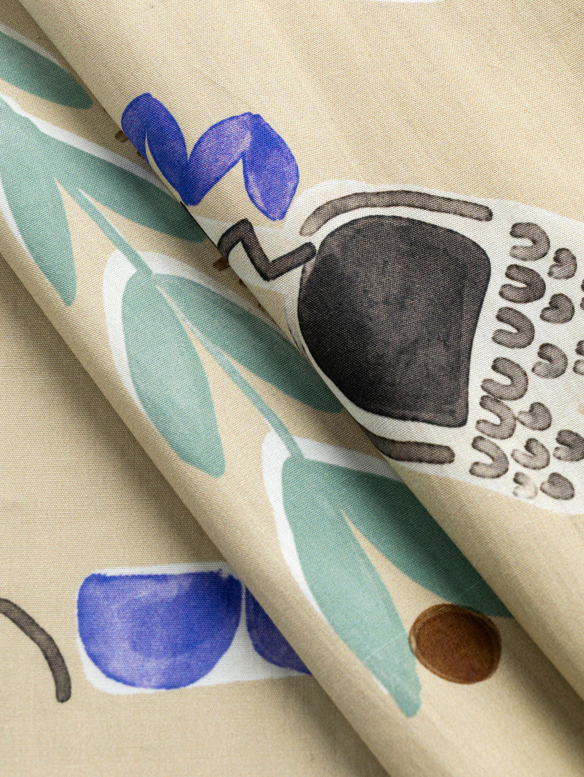 F-COT482-Painterly-Flower-Print-BCI-Cotton-Poplin-Oat-Periwinkle-and-Black-Core-Fabrics-fold.webp