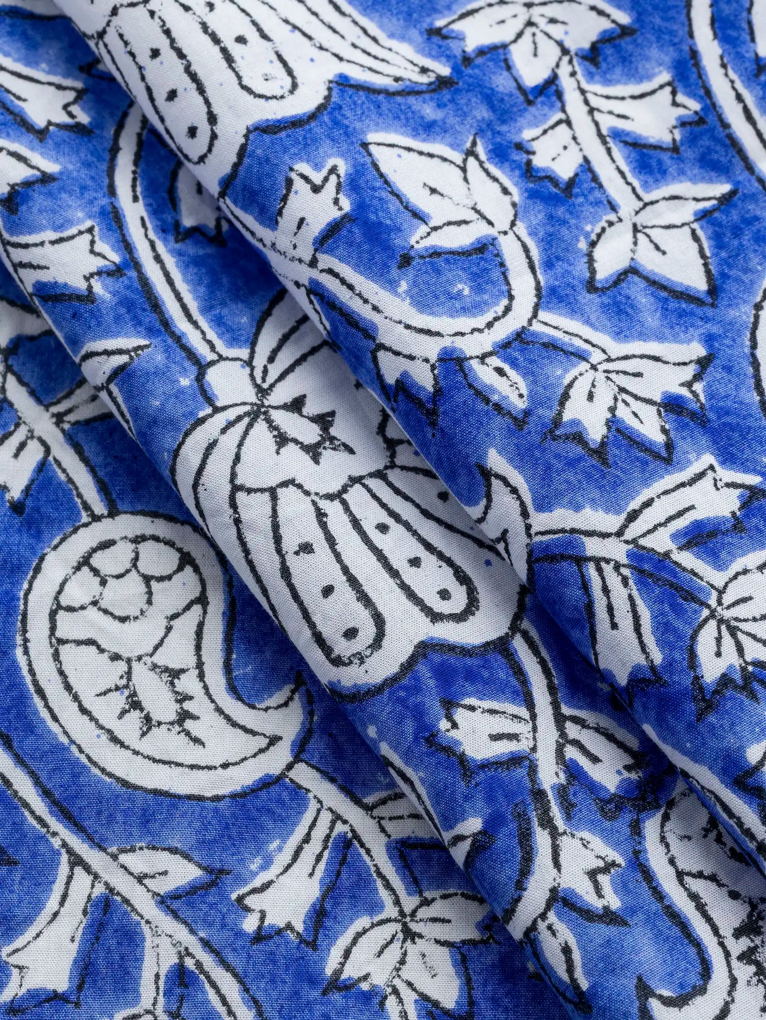 F-COT490-Paisley-Block-Print-Cotton-Poplin-Periwinkle-Ivory-and-Black-Core-Fabrics-fold.webp