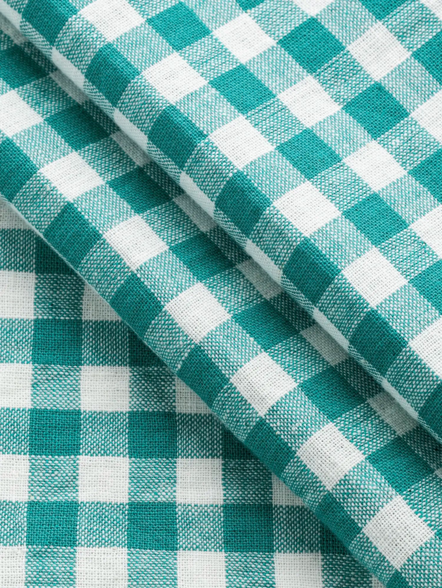 F-COT352-012-Parasol-Handwoven-Gingham-Cotton-Emerald-and-Ivory-Core-Fabrics-fold.webp