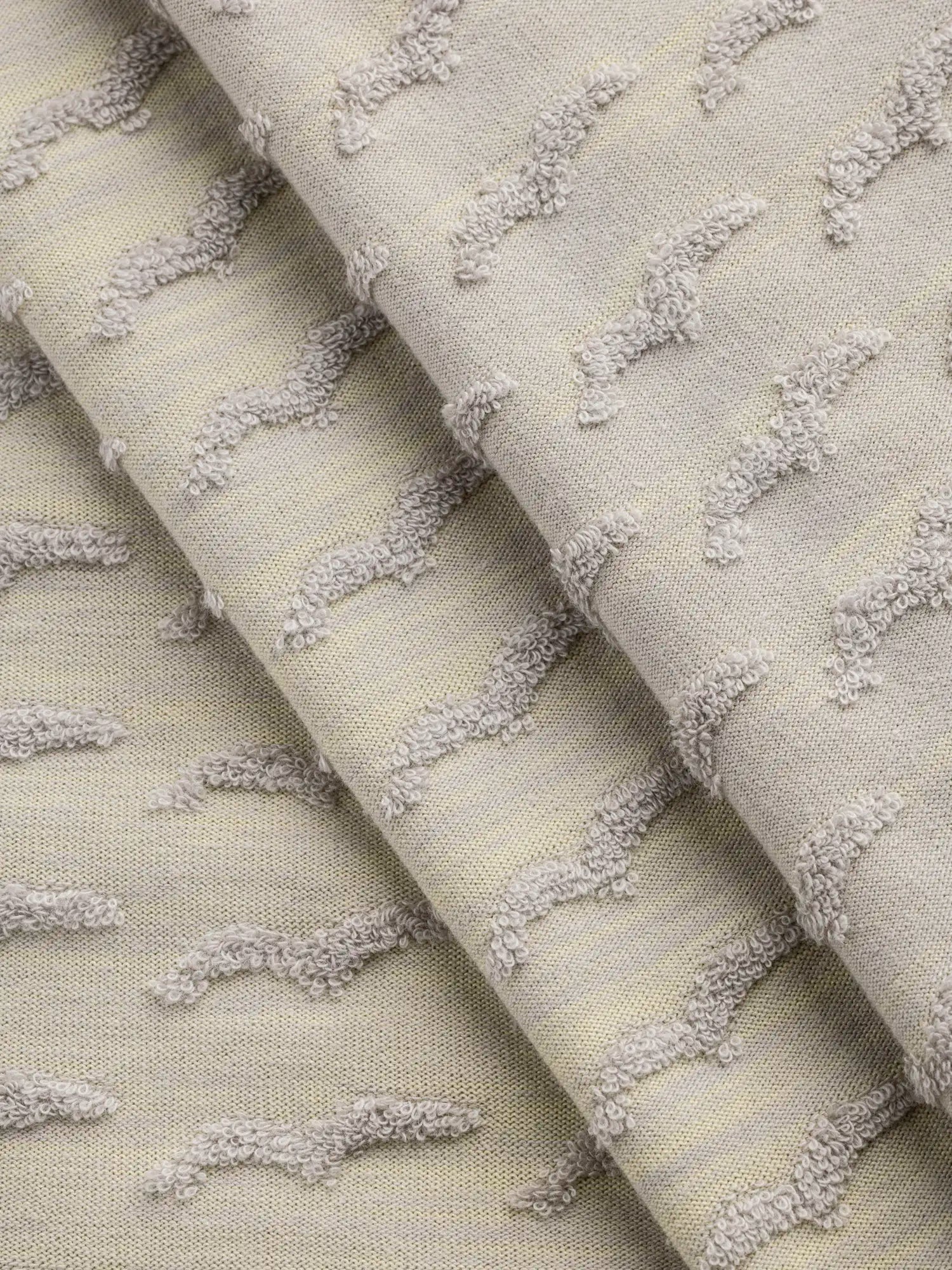 F-DEA157-Patterned-French-Terry-Knit-Deadstock-Heather-Grey-and-Yellow-Core-Fabrics-fold.webp