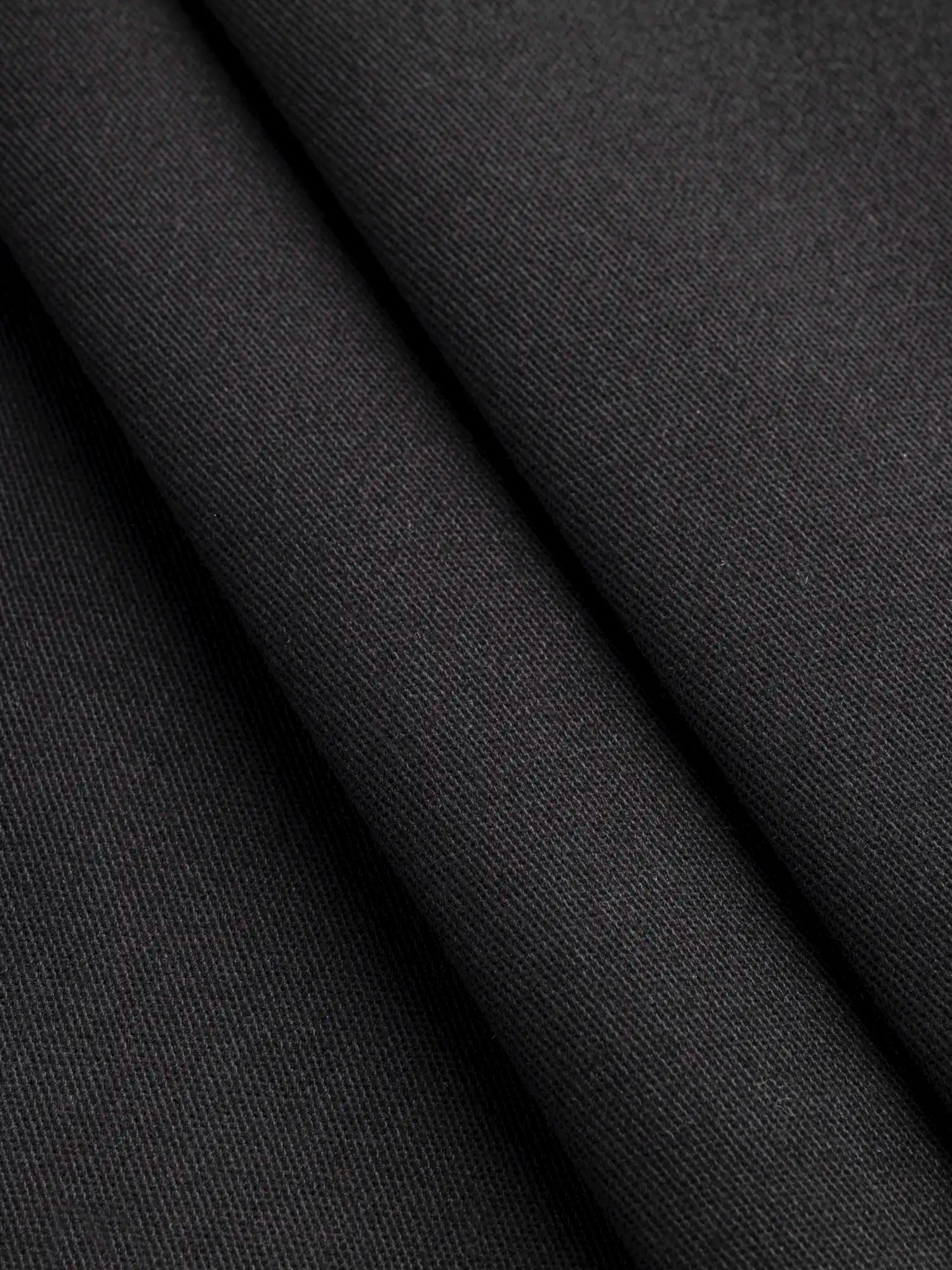 F-DEA167-001-Peached-Stretch-Canvas-Deadstock-Black-Core-Fabrics-fold.webp