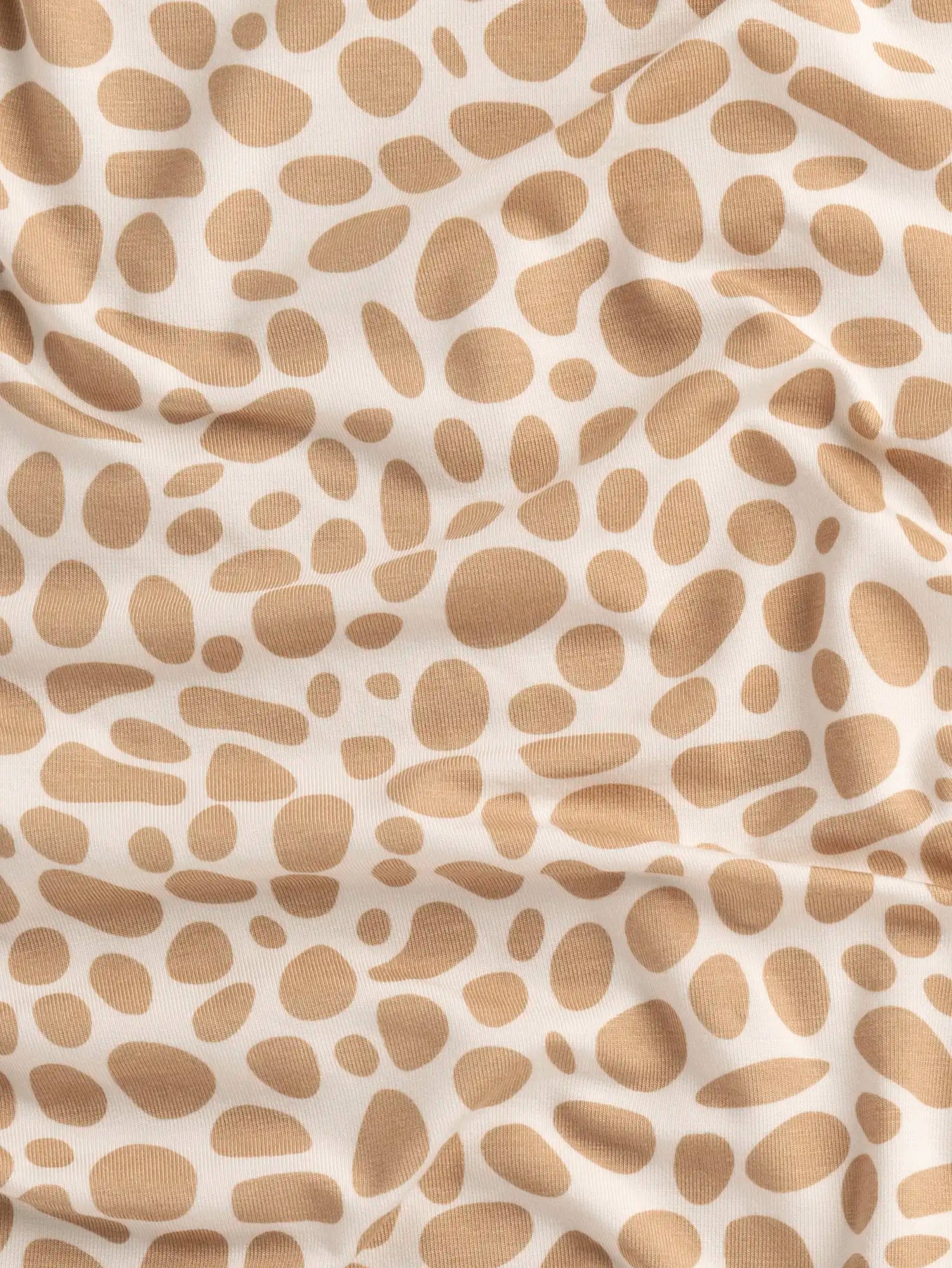 F-DEA235-Pebble-Print-Bamboo-Spandex-Knit-Deadstock-Ivory-and-Sand-Core-Fabrics-scrunchced.webp