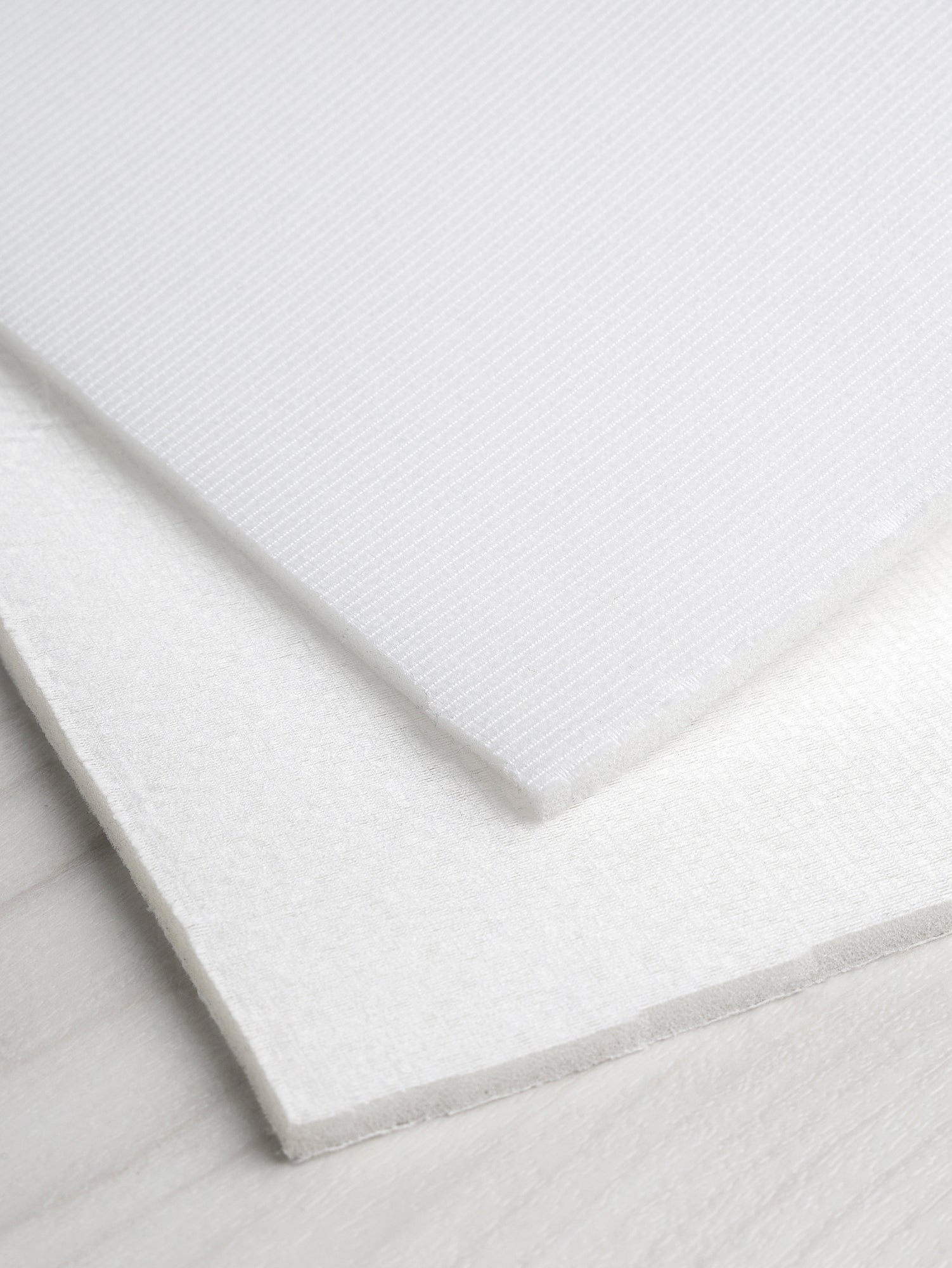 N-INT014-Pellon-Flex-Foam-1-Sided-Fusible-White-Core-Fabrics-fold.JPG