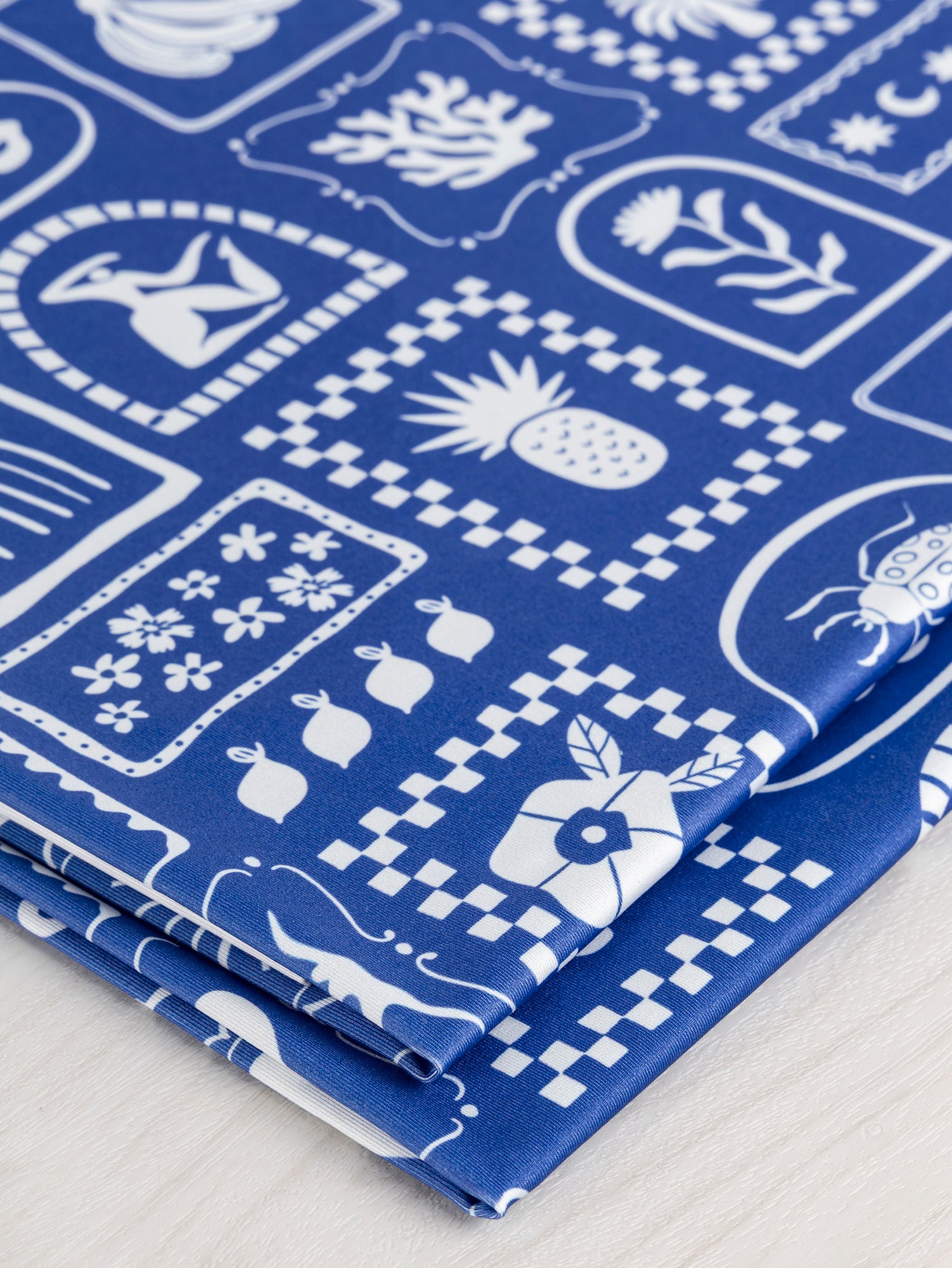 F-PES037-Picnic-Tile-Print-Recycled-Swim-Performance-Knit-Royal-Blue-and-White-Core-Fabrics-fold.JPG