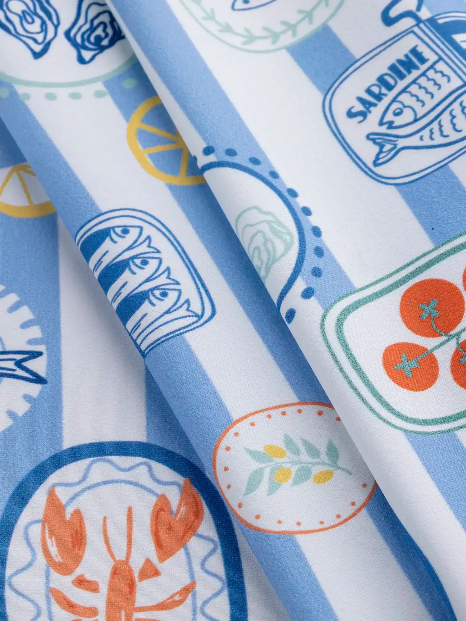 F-NYL023-Picnic-à-la-Mer-Print-Swim-Performance-Knit-Light-Blue-White-and-Multicolour-Core-Fabrics-fold.webp
