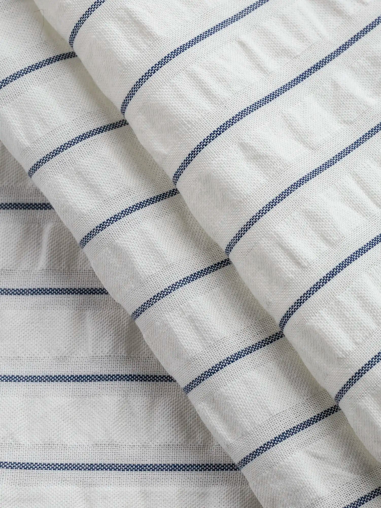 F-COT461-Pinstripe-Cotton-Seersucker-White-and-Indigo-Core-Fabrics-fold.webp