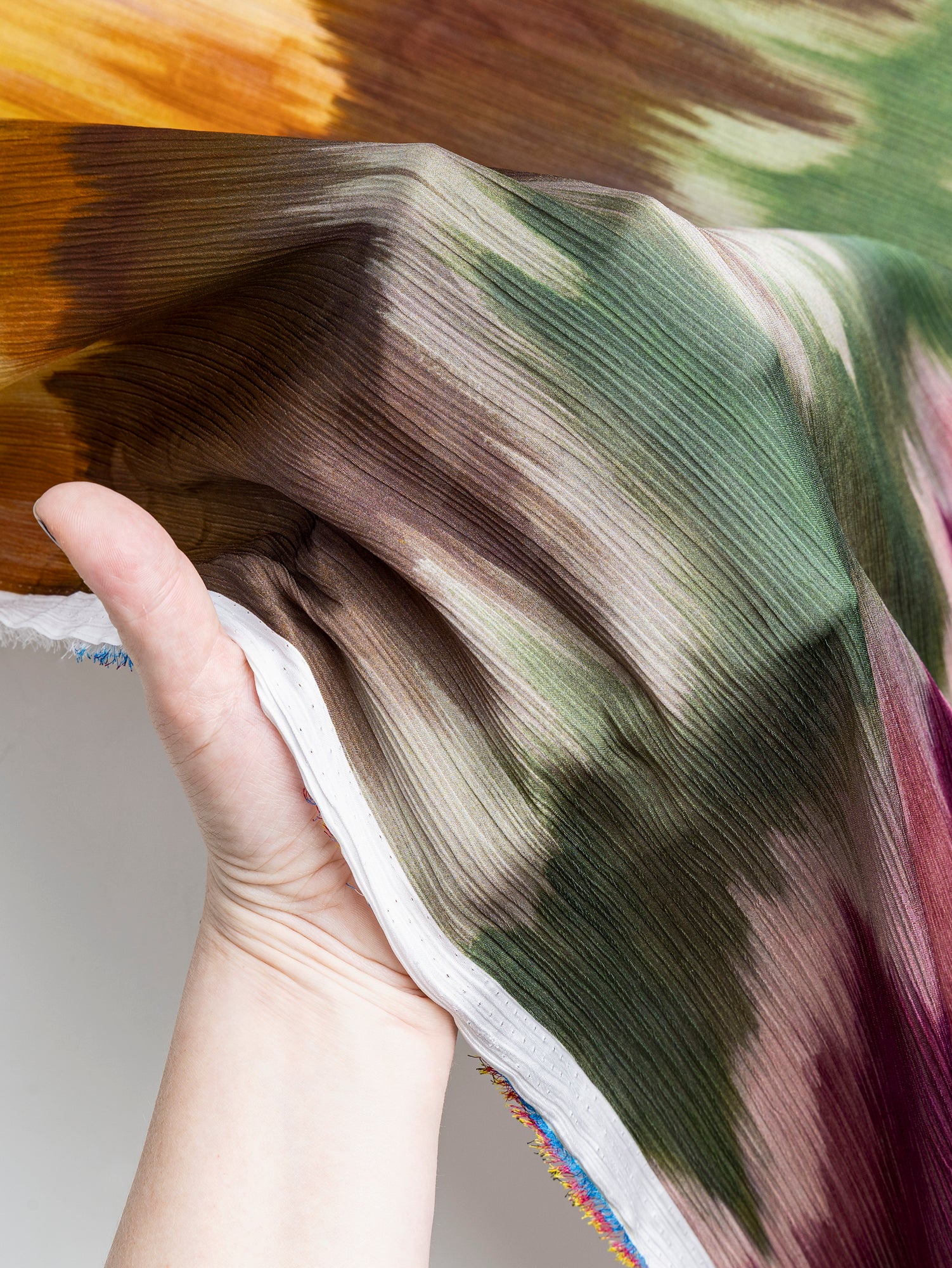 F-DEA073-Pleated-Wave-Print-Georgette-Deadstock-Magenta+Green+Ochre-Core-Fabrics-hand.JPG