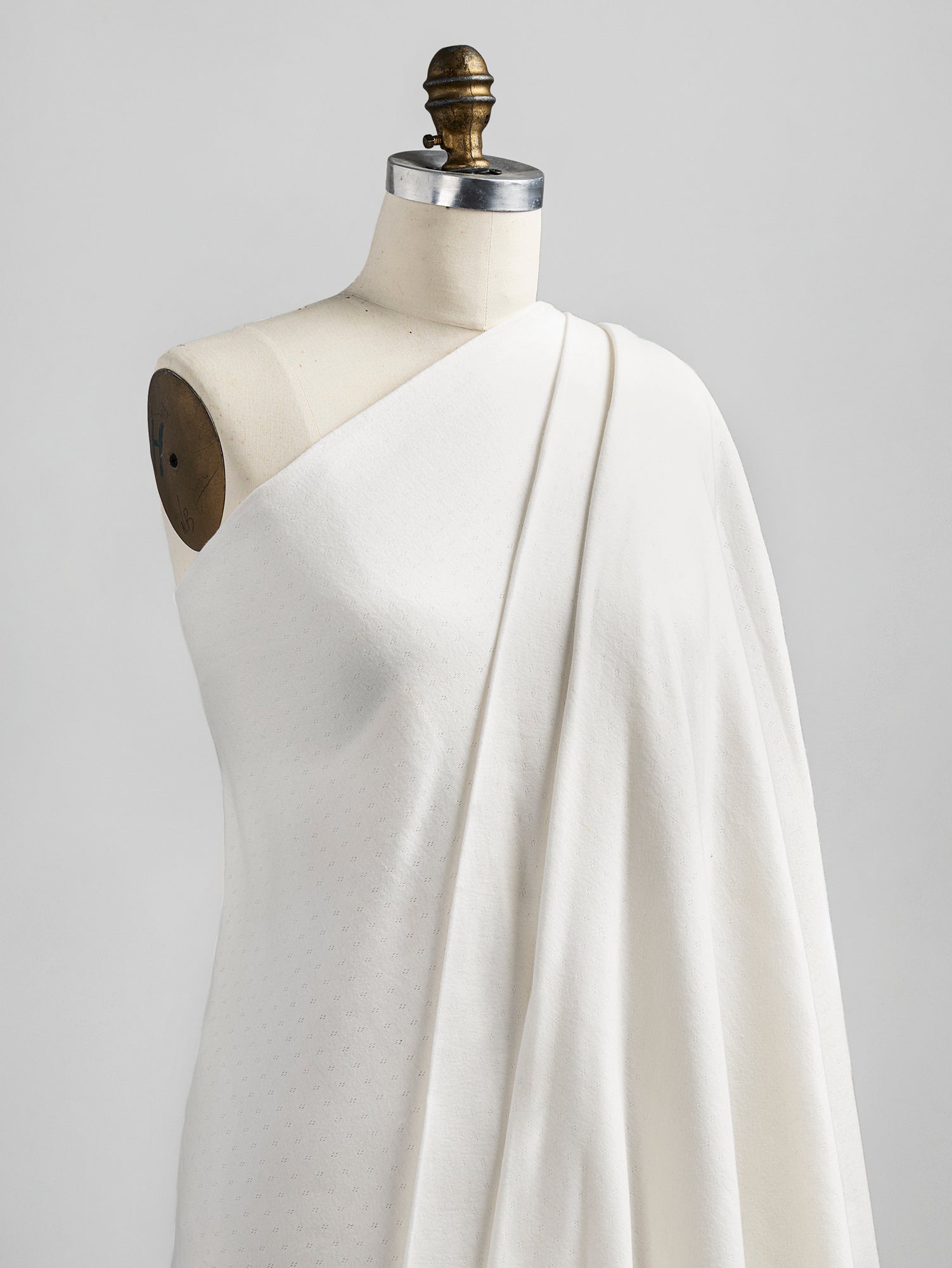 F-COT329-001-Pointelle-Jersey-Knit-Cream-Core-Fabrics-draped