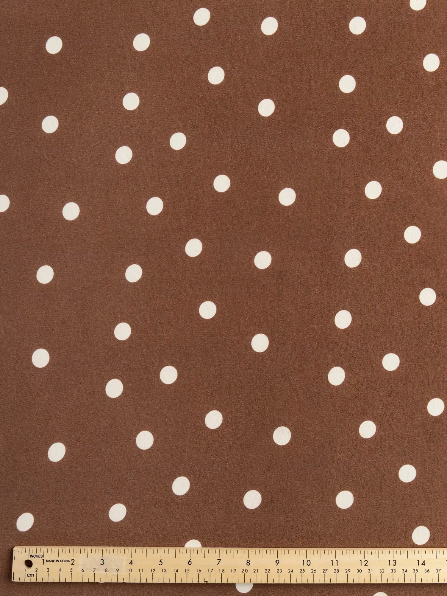 F-VIS294-Polka-Dot-Print-Ecovero-Crepe-de-Chine-Caramel-and-White-Core-Fabrics-ruler.webp