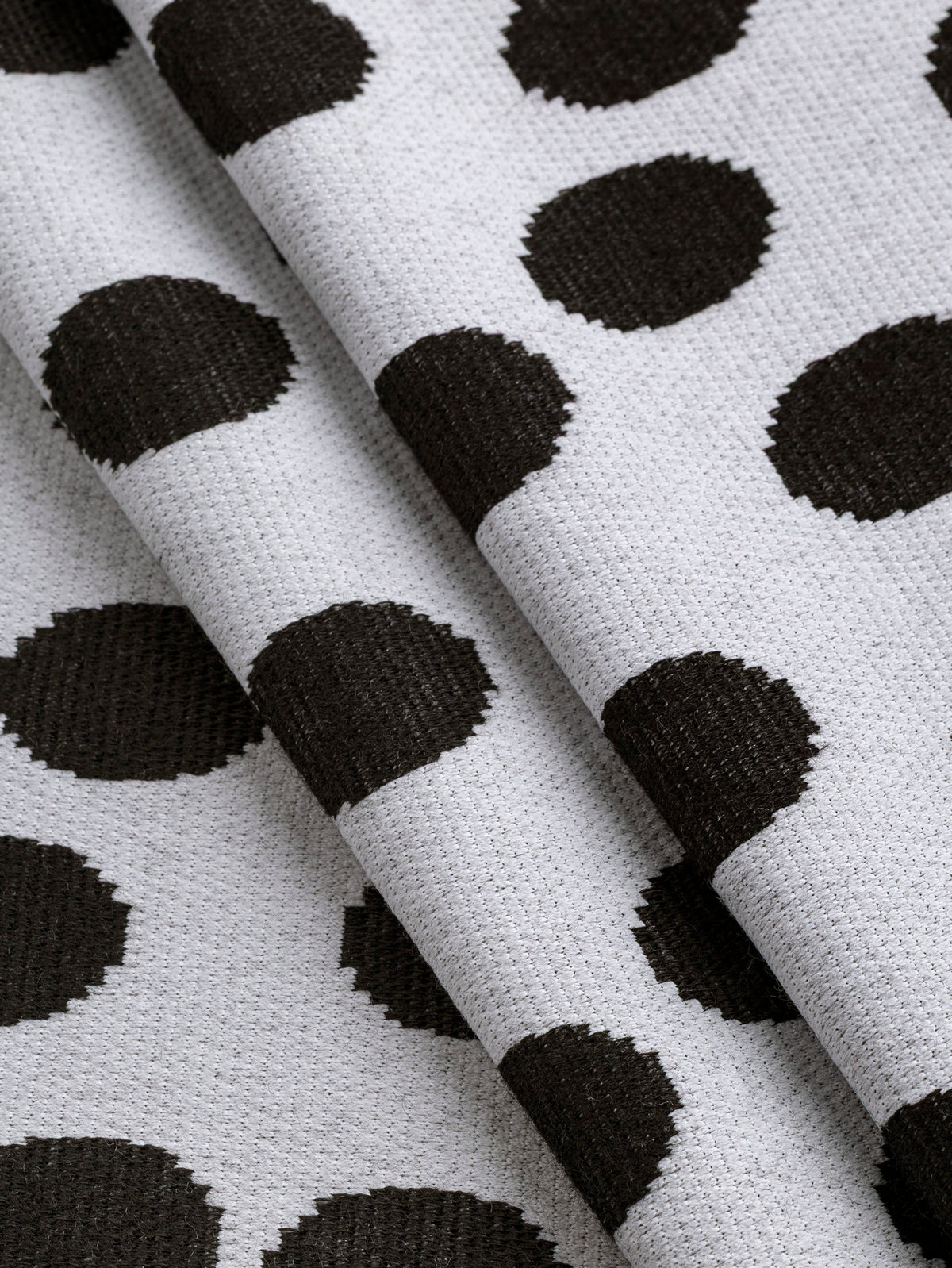 F-DEA255-Polka-Dot-Stretch-Knit-Deadstock-Pearl-and-Black-Core-Fabrics-fold.webp