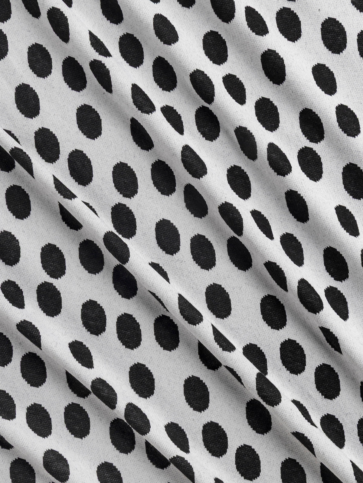 F-DEA255-Polka-Dot-Stretch-Knit-Deadstock-Pearl-and-Black-Core-Fabrics-scrunched.webp